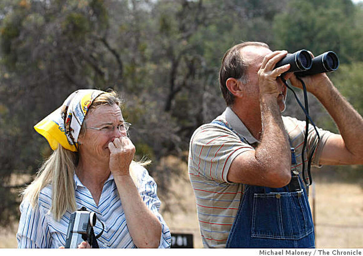 Jennifer Strawbridge and her husband Harry watch their property go up in flames on the slopes of Mt Bullion near Mariposa. The Strawbridge's are from Atwater and were building a retirement home on the site.Nearly 1,000 firefighters from throughout the state fought a fast growing wildfire that burned over 18,000 acres near Midpines, Calif., on July 27, 2008. Photo by Michael Maloney / The Chronicle