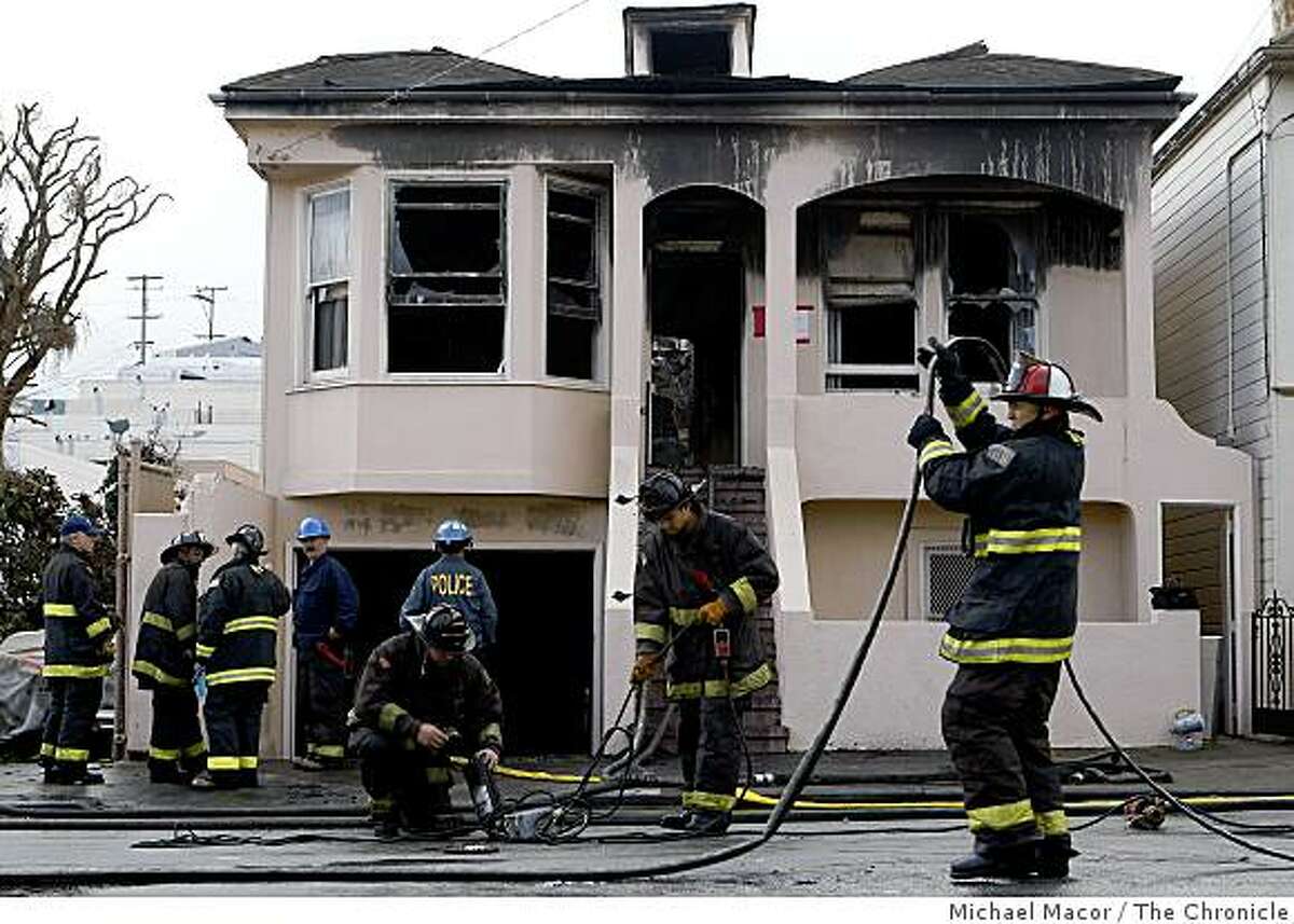 Firefighters clean up the scene of an early morning fire at 627 Felton St. in San Francisco. The fire left one firefighter with life-threatening injures.