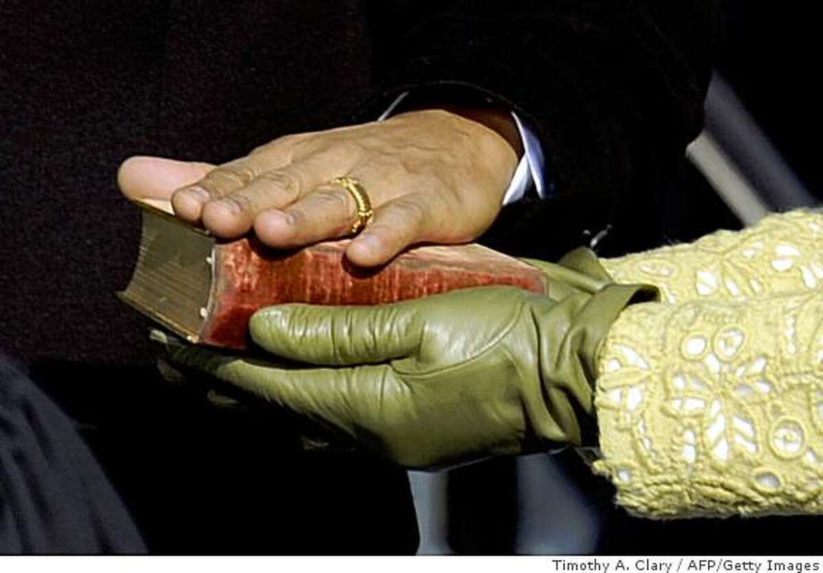 Barack Obama's hand lies on a bible as he is sworn in as the 44th US president by Supreme Court Chief Justice John Roberts in front of the Capitol in Washington on January 20, 2009.
