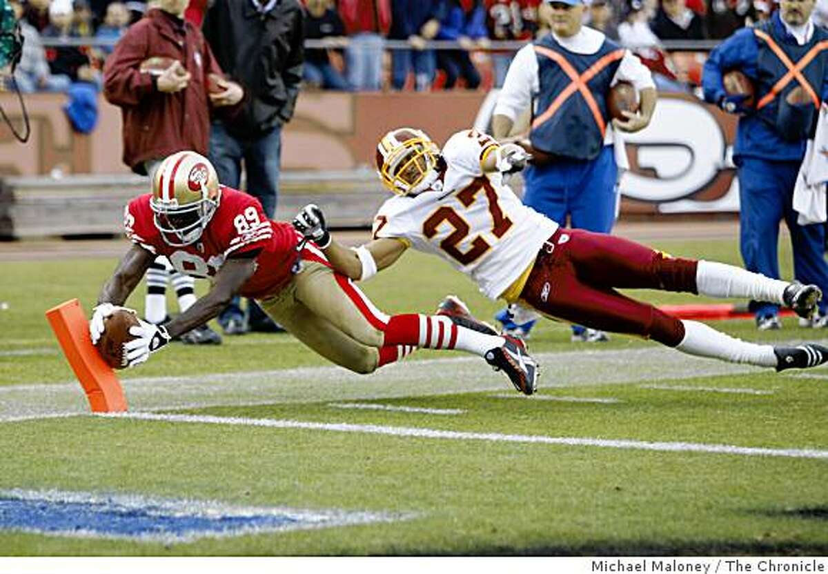 San Francisco 49ers Jason Hill (89) scores in the 4th quarter of a game hosted by the 49ers at Candlestick Park on Sunday, December 28, 2008. Covering him is Washington Redskins Fred Smoot (27). The 49ers won 27-24.
