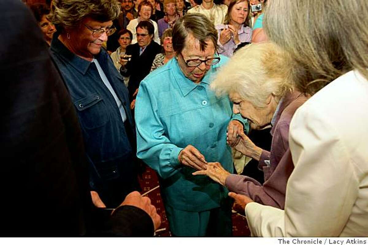 After 55 years Phyllis Lyon slips a wedding ring on Del Martins' finger during their wedding ceremony by Mayor Gavin Newson, Monday June 16, 2008, in San Francisco, Calif. Chronicle photo by Lacy Atkins.