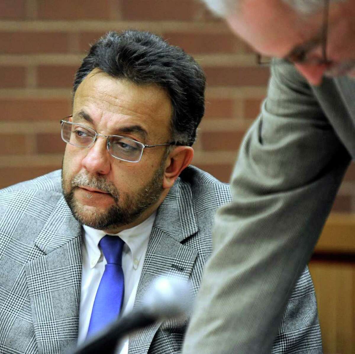 Joseph DaSilva Jr., left, listens to the proceedings Wednesday at the State Superior Court in Danbury, where he is on trial for manslaughter. Photo taken Wednesday, Jan. 11, 2012.