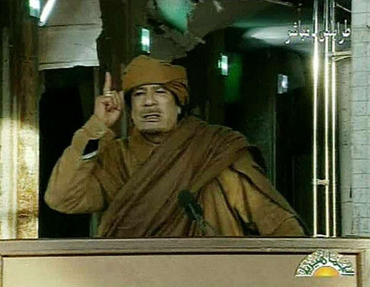 This image broadcast on Libyan state television Tuesday, Feb. 22, 2011, shows Libyan leader Moammar Gadhafi as he addresses the nation in Tripoli, Libya. Libya's Gadhafi vowed to fight on against protesters demanding his ouster and die as martyr.