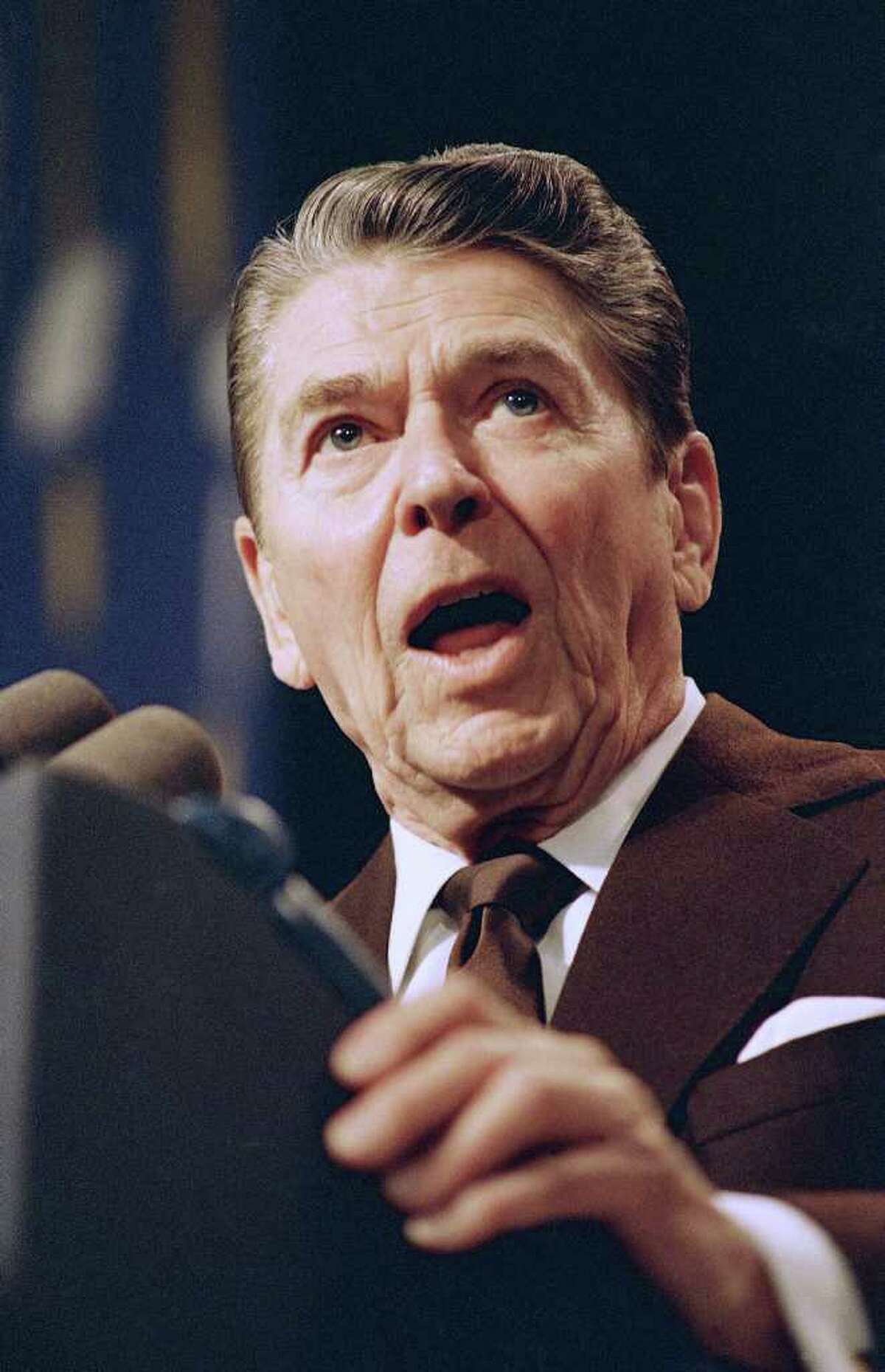 FILE - In this April 21, 1988 file photo, President Ronald Reagan speaks in Springfield, Mass. What gives? Some of Mitt Romney?s rivals are waging a fierce attack on him that you?d never think would come from the mouths of Republicans who claim Ronald Reagan as their hero. They?re blasting the GOP front-runner for aggressive wealth-creating business tactics, a criticism that has the party in an uproar. (AP Photo/Ron Edmonds, File)