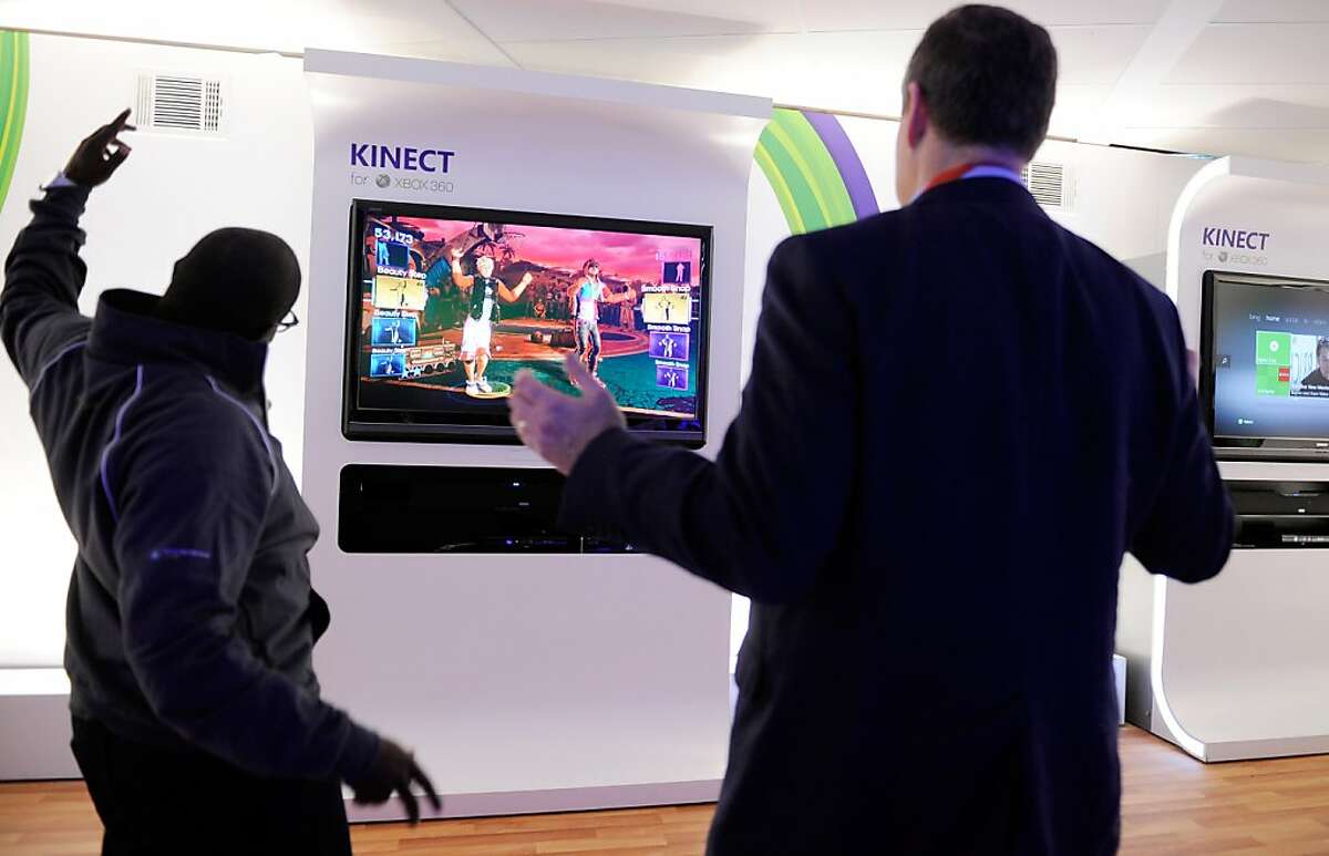 LAS VEGAS, NV - JANUARY 10: Microsoft representative Derrick Stanfield Kivoi (L) and Bernard Groveman dance to Microsoft's Xbox 360's 'Dance Central 2' using the Kinect at the 2012 International Consumer Electronics Show at the Las Vegas Convention Center January 10, 2012 in Las Vegas, Nevada. CES, the world's largest annual consumer technology trade show, runs through January 13 and is expected to feature 2,700 exhibitors showing off their latest products and services to about 140,000 attendees. (Photo by David Becker/Getty Images)