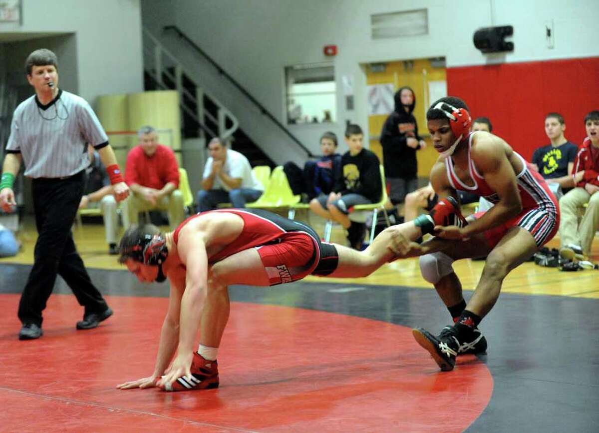 Greenwich's Ryan Whittle grabs a hold of Fairfield Warde's Joey Muratori, during boys wrestling action in Fairfield, Conn. on Wednesday January 11, 2012.