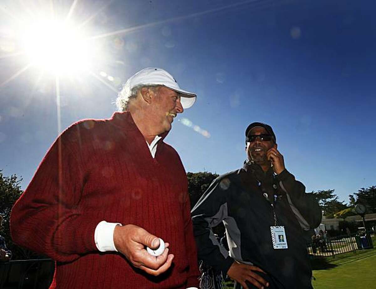 Amateur golfers Joe Rice, an attorney, Darius Rucker, lead singer for Hootie and The Blowfish, talk on the practice green at the annual AT&T Pro-Am at Pebble Beach on Tuesday.