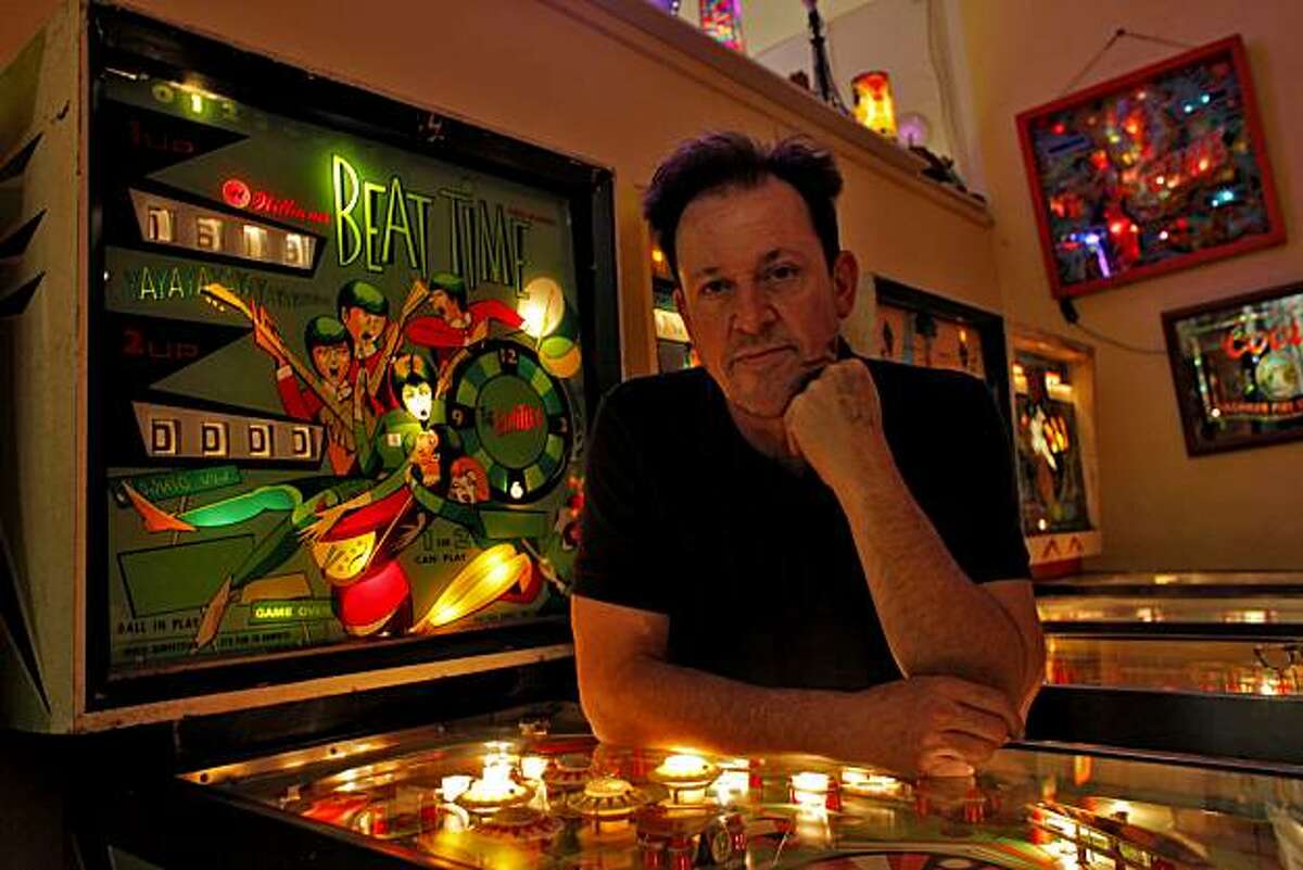 Michael Schiess, who with his wife own the non-profit Pacific Pinball Museum, stands with a game that was designed after the "Beattles", in the 70's ,Tuesday January 25, 2011, in Alameda, Calif.