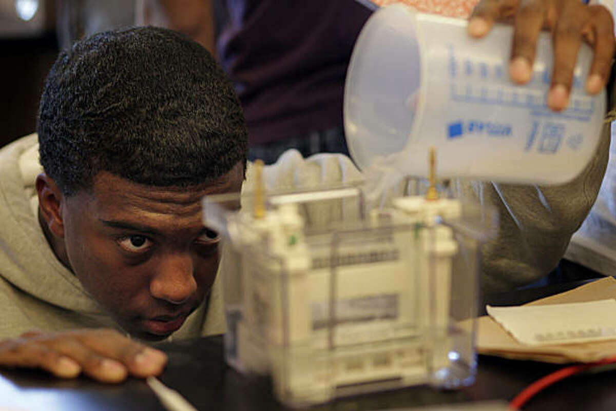 DeLeon Johnson, a senior in the Biotech class at Lincoln High School pours liquid into a Polyacrylamicle Gel Electrophoresis Machine, Tuesday January 25, 2011, in San Francisco, Calif. His class exemplifies the school's focus on science, which emphasizes problem solving and the ability to apply scientific principles.