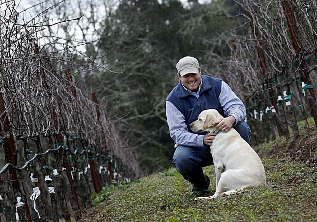 Matt Taylor pauses to praise his dog Zion who gets to go to work with him Tuesday January 11, 2011. Matt Taylor has been named one of the "Winemakers to Watch" and is making his own Pinot Noir near his biodynamic self-contained farm near Healdsburg, Calif.