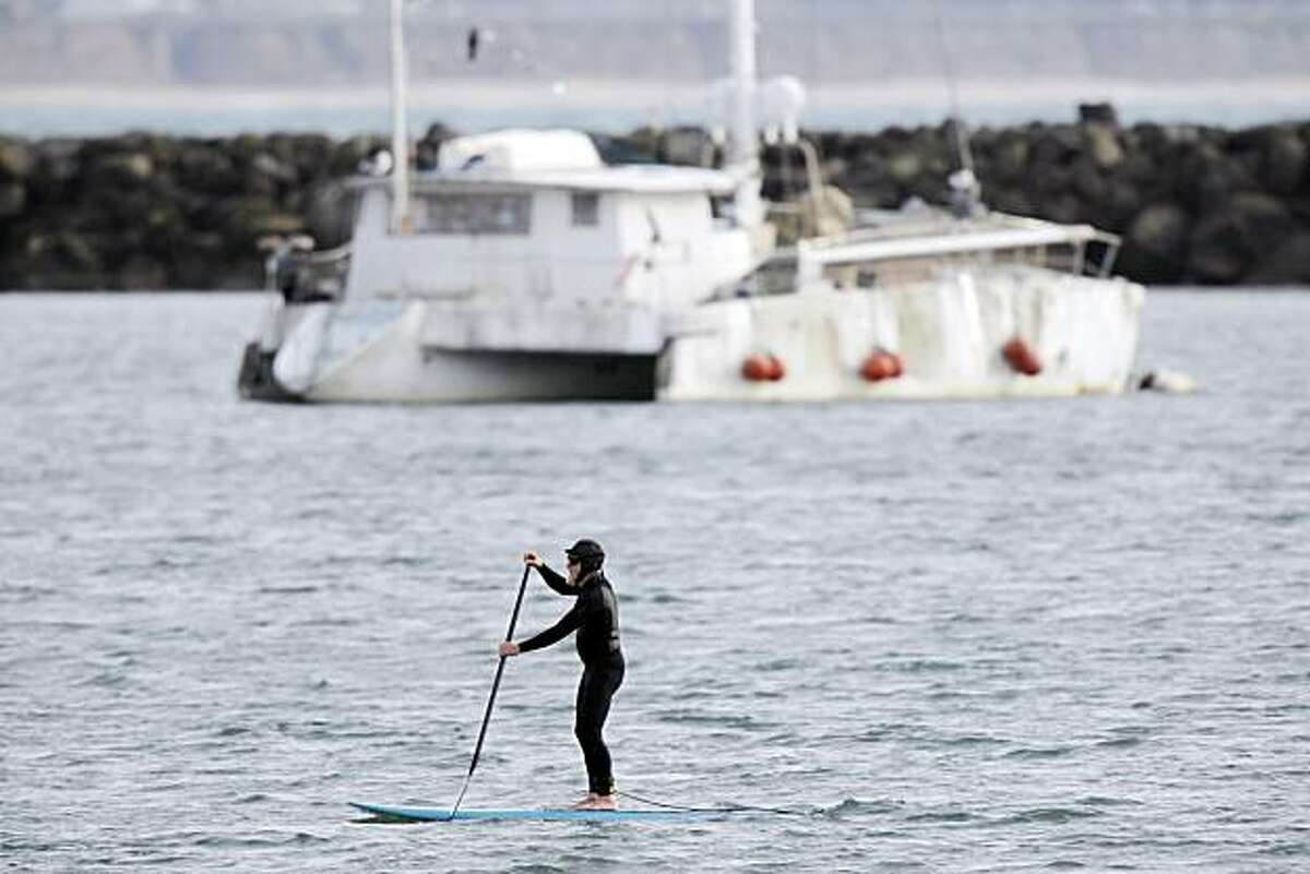 A paddle surfer makes his way through the calm waters of Pillar Point Harbor near Half Moon Bay, Calif., on Friday, Calif. Urban Outings feature on Pillar Point, near Half Moon Bay. If you're tired of cold, gray Bay Area beaches with crashing waves, stroll out to sheltered, peaceful Pillar Point where gentle currents lap at a sandy beach and delicate clam shells crunch underfoot. Protected by Pillar Point Harbor, Pillar Point is part of the Fitzgerald Marine Reserve, which extends from the Montara light station south to Pillar Point.