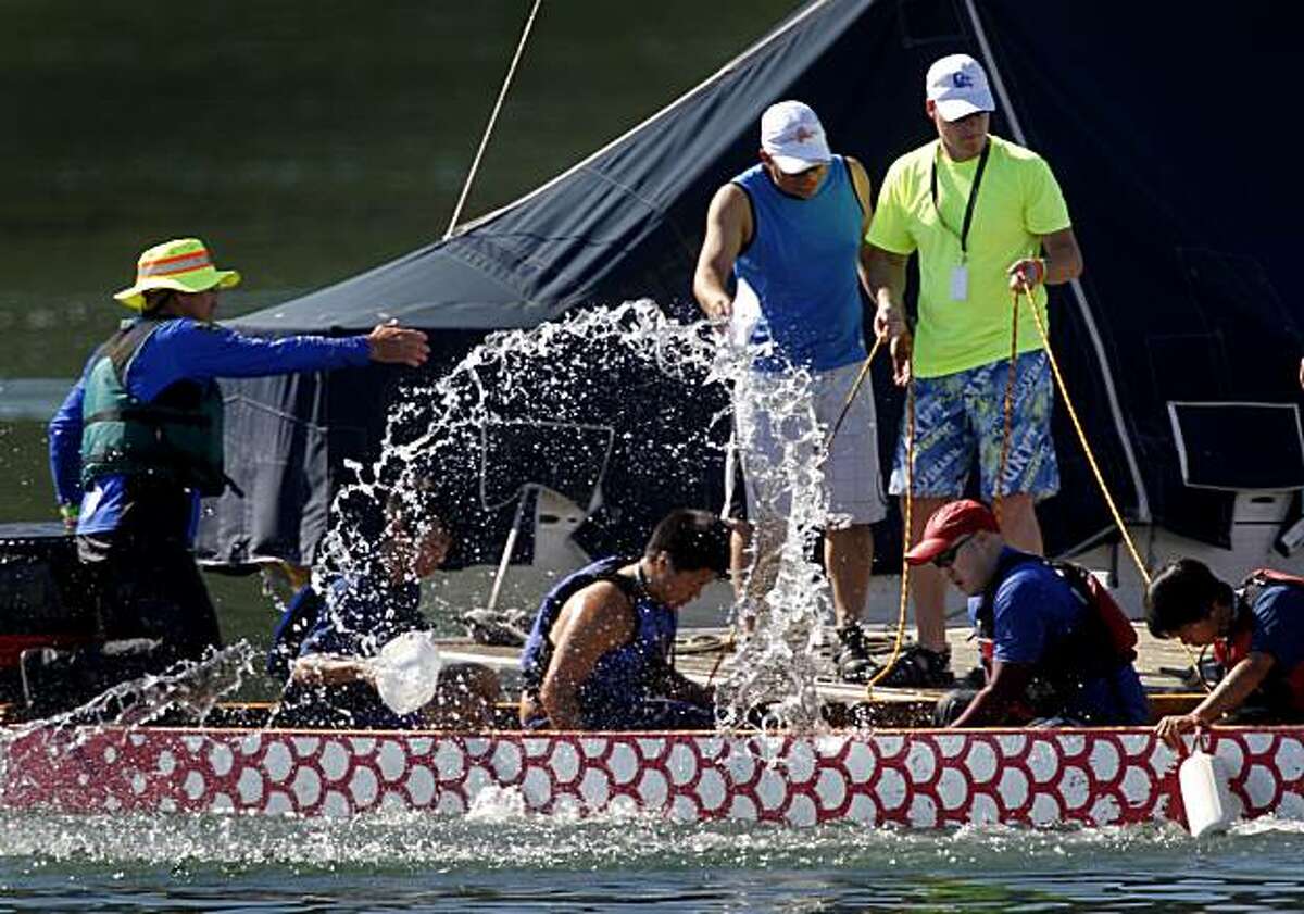 Volunteers bail water after an overly excited team splashed too much into the dragon boat during a race in the 15th annual San Francisco International Dragon Boat Festival at Treasure Island on Saturday. More than 100 teams are participating in this year's event, which organizers say is the largest dragon boat racing competition in the United States. Teams of paddlers race on either a 300-meter or 500-meter course during the two-day festival, which concludes Sunday.