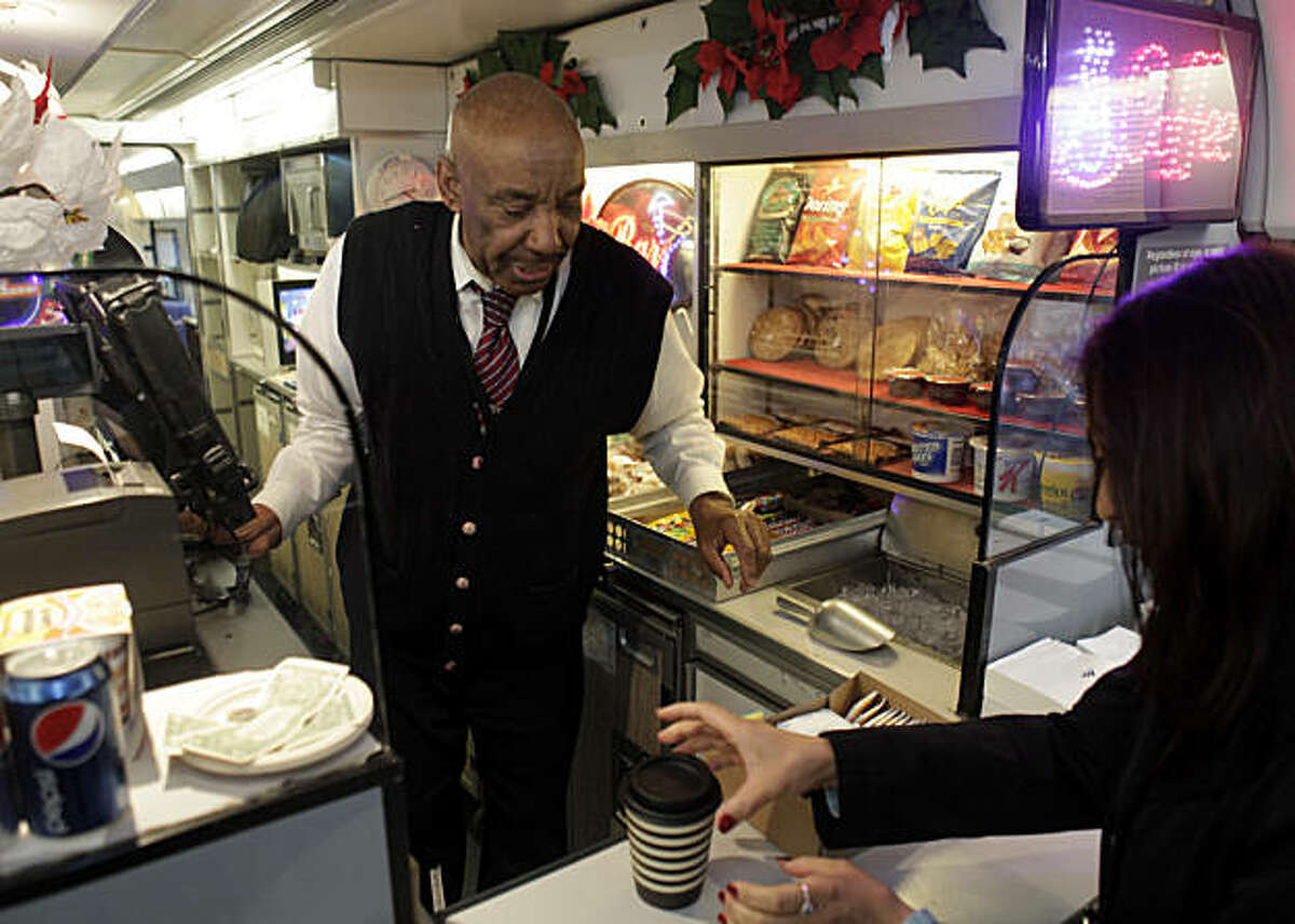 Herman Davison, a lead service attendant on the Capitol Corridor Amtrak train, helps a customer on the cafe car on a train headed for Sacramento, Calif., from Emeryville, Calif., on Tuesday, December 28, 2010. While high-speed rail in California is getting all the attention, the state's lower-speed intercity trains are seeing a boom in popularity. Trains like the Capitol Corridor have seen a double digit rise in passengers. (Luna)