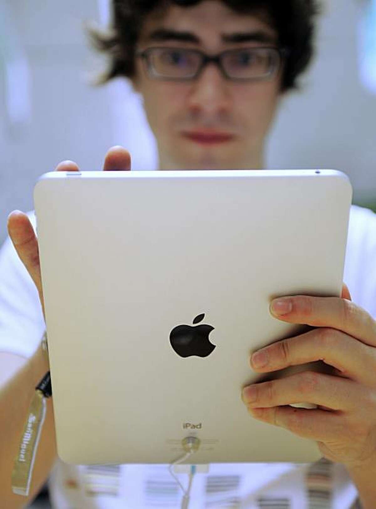 A customer hold the new iPad tablet computer at an Apple store in central in Barcelona, Spain, Friday, May 28, 2010. Apple Inc. launched the iPad in nine countries on Spain, Friday, Australia, Canada, France, Germany, Italy, Japan, Switzerland and Britain, and shoppers queued in the hopes of getting the hand-held computer(. AP Photo/Manu Fernandez)