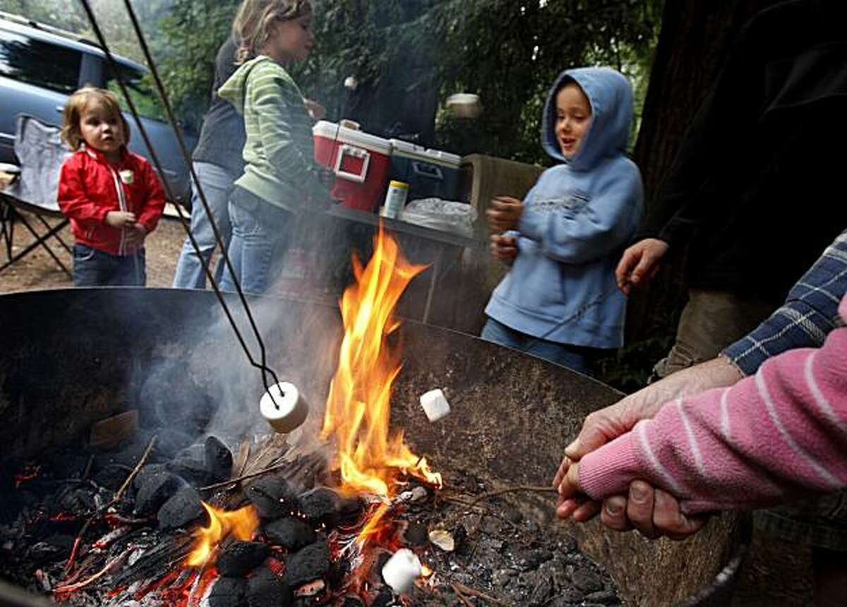 Members of the Brondum family including Anna Lise, left, Lauren and Isaac, in blue sweatshirt plan to try a new "smores" recipe beginning with marshmallow cooking. Many Northern California campers may soon have to do without the traditional campfire, but at Samuel P. Taylor Park in Marin County campfires are still permitted. Many federal and state parks are ending campfires in an attempt to prevent wildfires. Photo by Brant Ward / The Chronicle