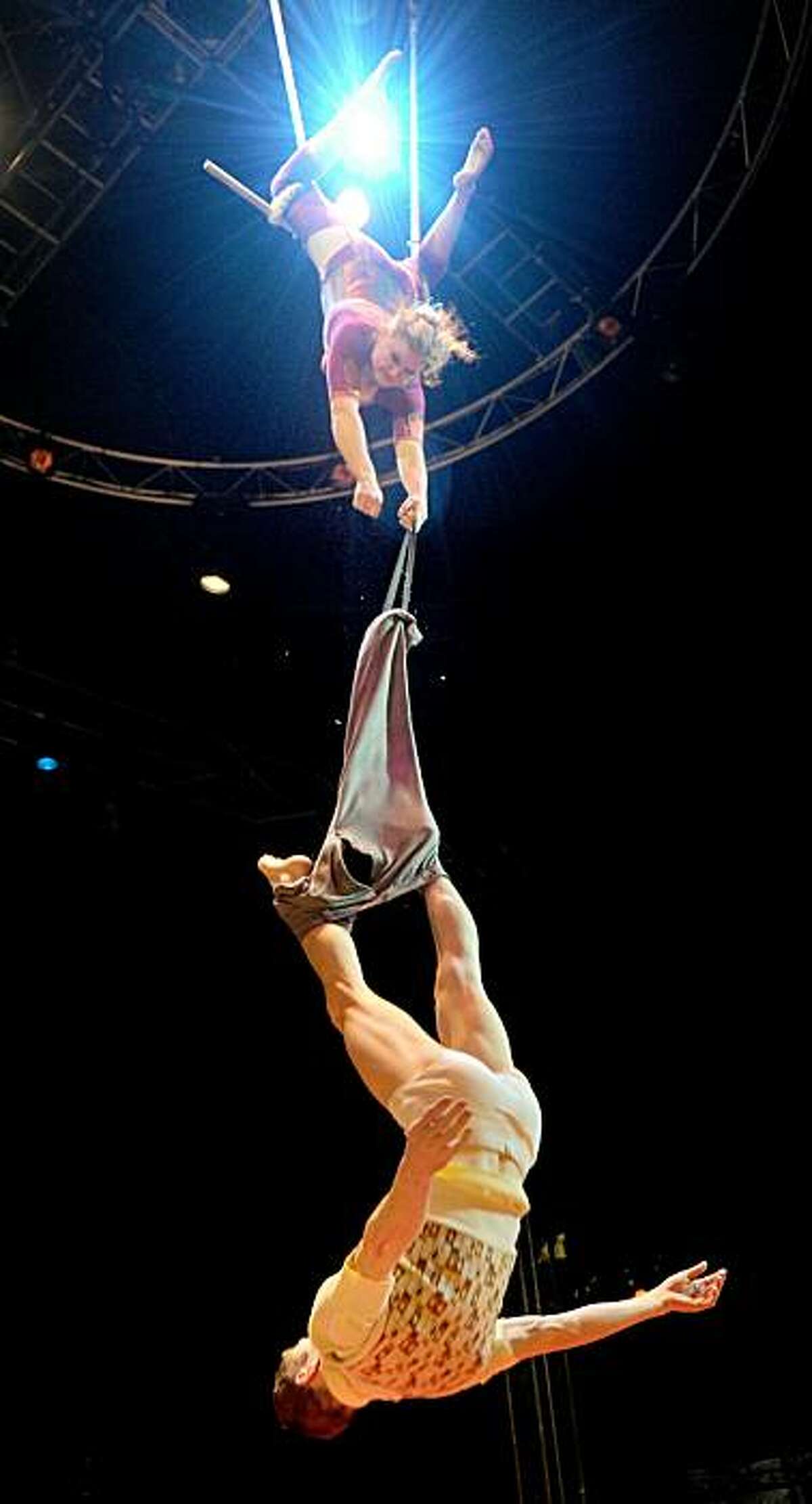 Two acrobats of Australia’s internationally acclaimed circus company, Circus Oz, perform their trapeze act during a rehearsal of their new production in the lead up to the opening night, in Melbourne on June 16, 2010. One of the very first 'new' or 'contemporary' circuses without animals, it predates most other nouveau cirque troupes and predates Cirque du Soleil by about six years. Circus Oz has performed in 26 different countries, across five continents to over two million people. They have broken box office records at the Edinburgh Fringe Festival and represented Australia at scores of international festivals.