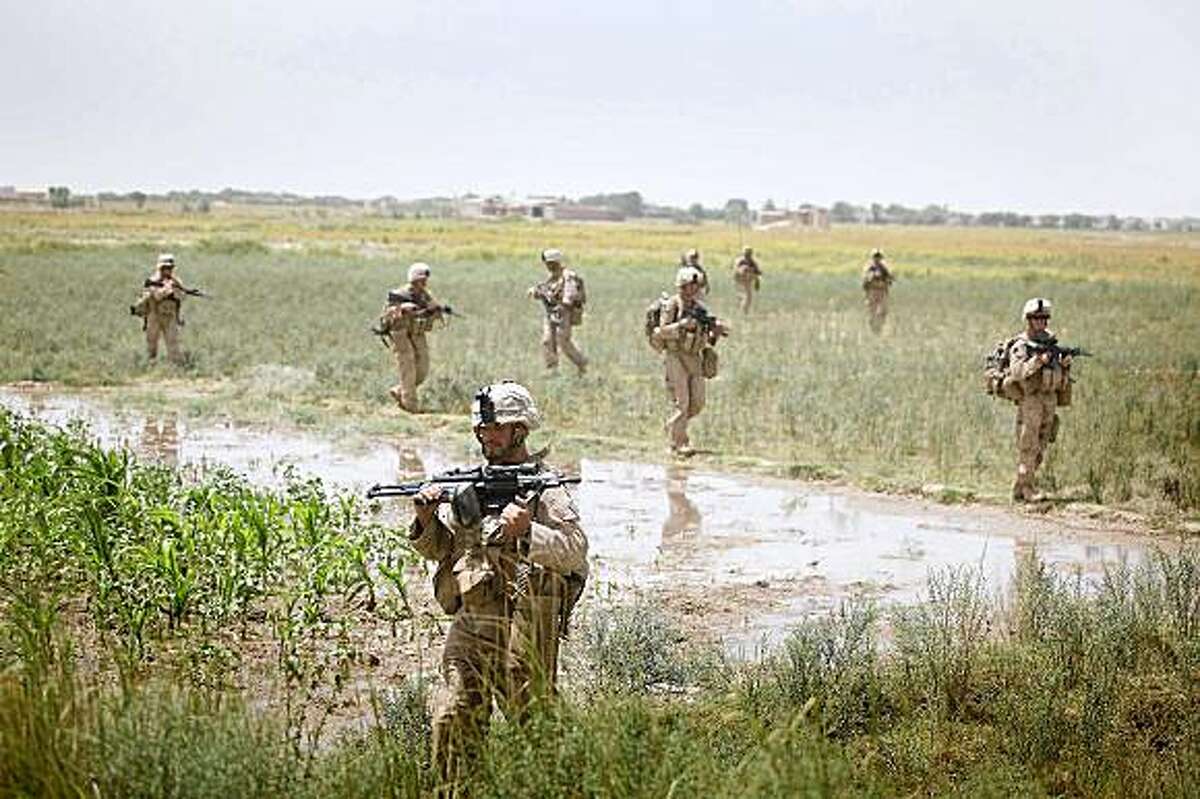 HERATI, AFGHANISTAN - JULY 19: U.S. Marines with the 2nd Marine Expeditionary Brigade, RCT 2nd Battalion 8th Marines Echo Co. conduct a movement to push Taliban fighters out on July 19, 2009 in Herati, Afghanistan. The Marines are part of Operation Khanjari which was launched to take areas in the Southern Helmand Province that Taliban fighters are using as a resupply route and to help the local Afghan population prepare for the upcoming presidential elections. (Photo by Joe Raedle/Getty Images)