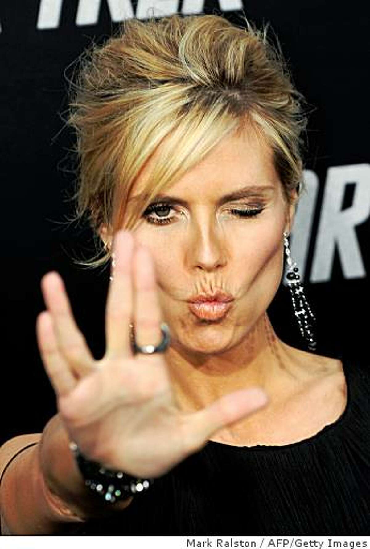 Model Heidi Klum flashes a "Star Trek" salute as she arrives at Grauman's Chinese Theatre in Hollywood for the premiere of the movie "Star Trek" in Los Angeles on April 30, 2009.