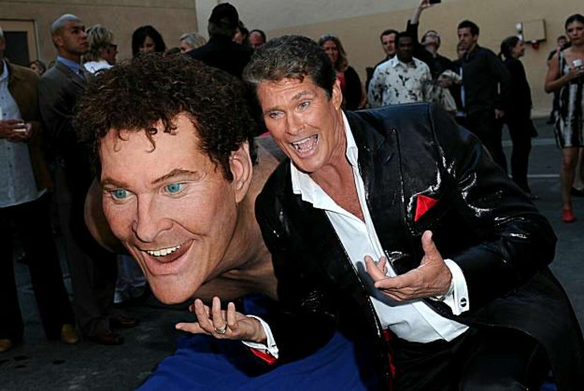 CULVER CITY, CA - AUGUST 01: Actor David Hasselhoff poses next to a giant replica of him as he arrives at the Comedy Central Roast Of David Hasselhoff held at Sony Pictures Studios on August 1, 2010 in Culver City, California. The "Comedy Central Roast of David Hasselhoff" will air on Sunday, August 15, 2010 at 10:00 p.m. ET/PT.