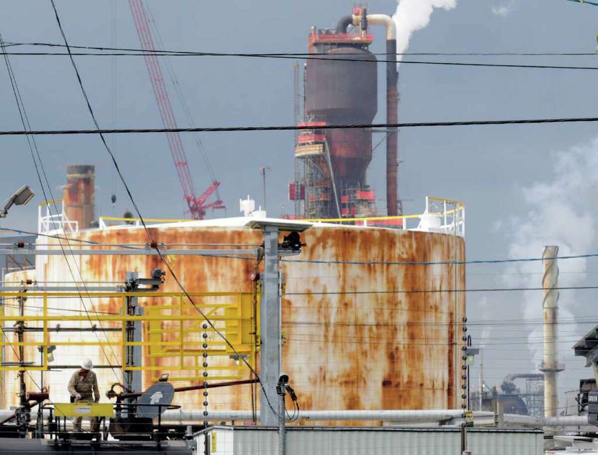 A man works at ExxonMobil’s Baytown refinery in September 2009. The refinery ranked among America’s top 50 emitters of greenhouse gases, EPA data shows.