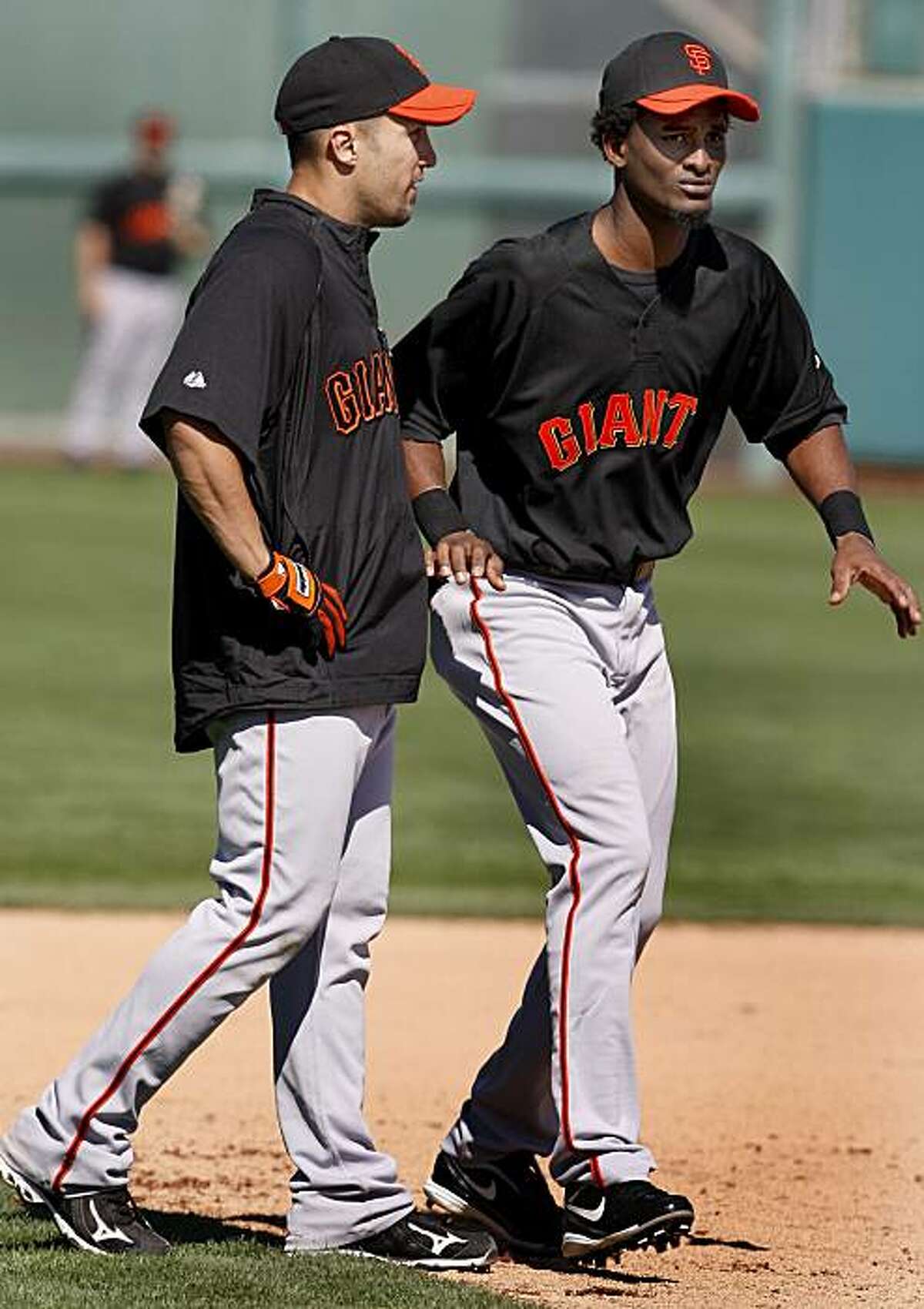 Giants speedsters Andres Torres (left) and Eugenio Velez (right) during a base running drill. Annual spring training action with the San Francisco Giants and Oakland Athletics from Scottsdale and Phoenix, Arizona.