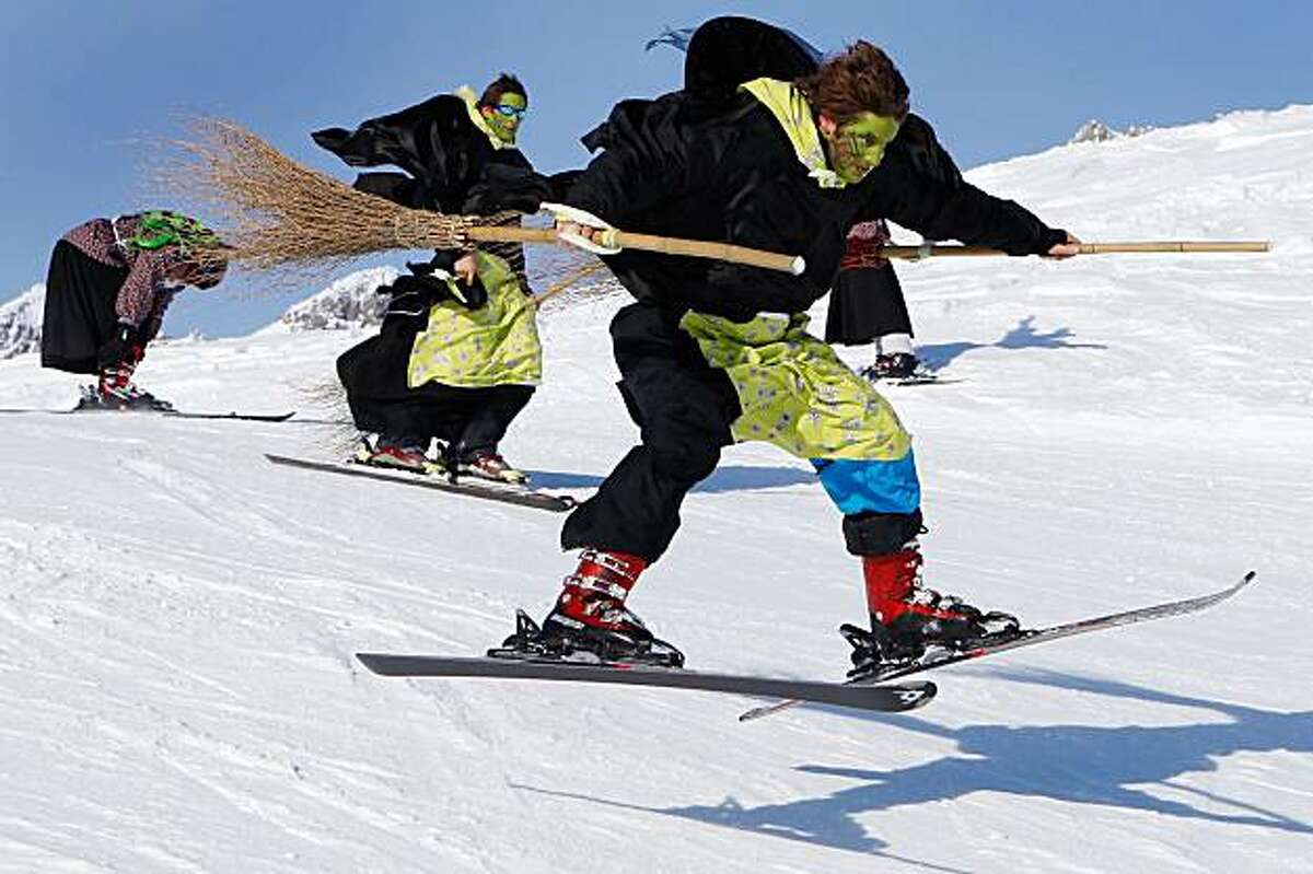 group of skiers disguised as witches participate in the 28th downhill race ...