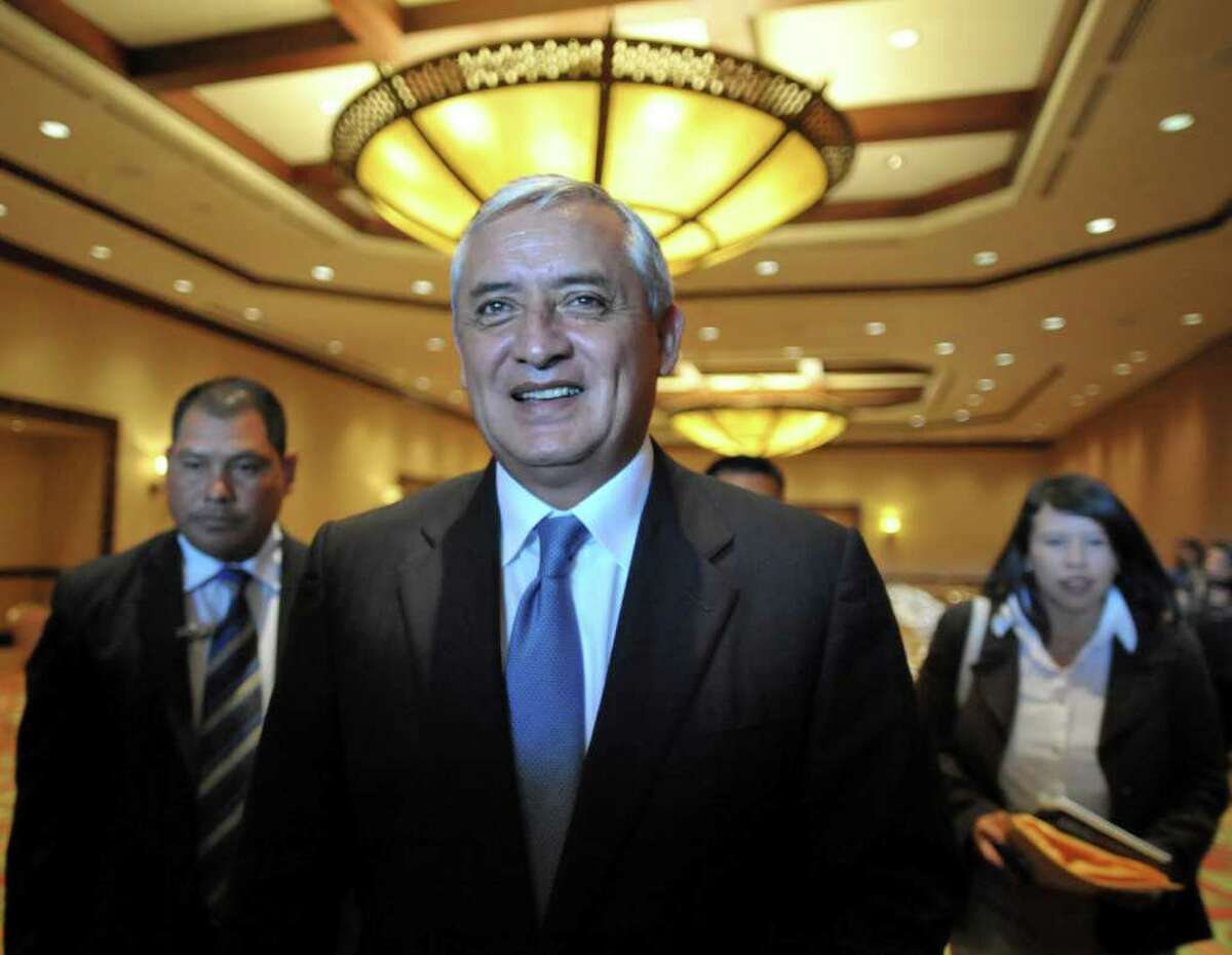 Guatemalan President-elect Otto Perez Molina smiles with journalists after holding a meeting with deputies of his party in Guatemala City, on January 12, 2012. Retired general Perez Molina is to succeed President Alvaro Colom when he takes office on January 14. AFP PHOTO/Johan ORDONEZ