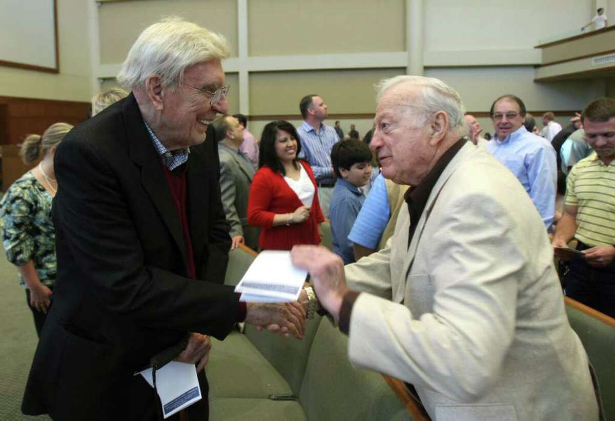 Pastor Guido Merkens (left) greets Sid Glenn after a service at Concordia Lutheran Church in 2009. Merkens founded the church, which now has about 6,000 members.