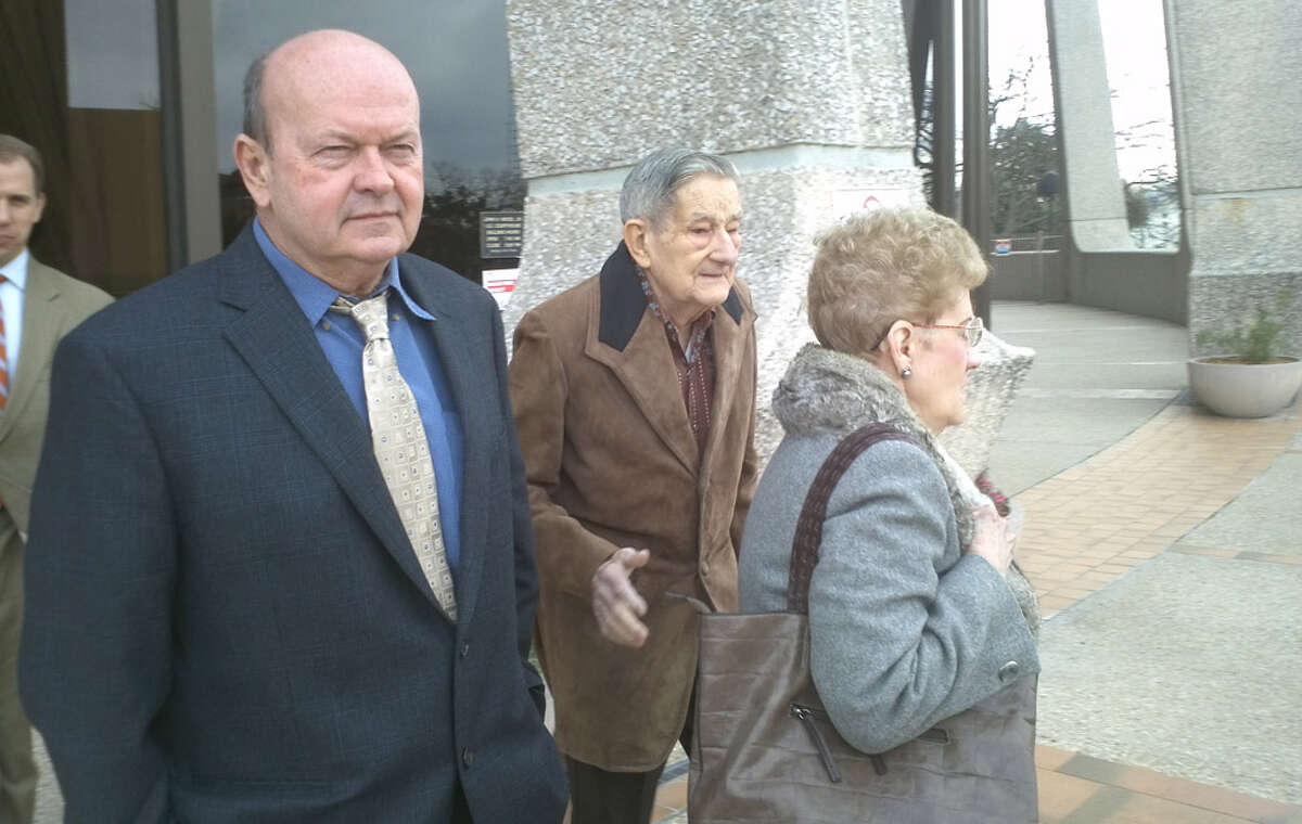 Eisenhauer flea market owner Bruce Gore (from left) leaves court with manager Pat Walker (in gray coat) and her husband, Bob. A federal jury found Gore and Pat Walker contributed to trademark infringement for letting vendors sell knockoff products depicting Louis Vuitton. The jury awarded Louis Vuitton $3.6 million.