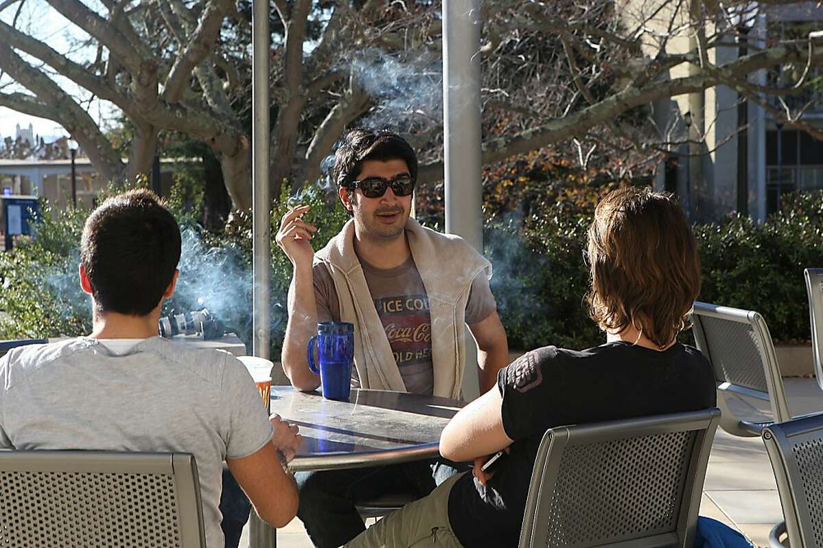 Manos Chamilothoris (left), Hasnain Bokhari (middle), and Matteo Carraro (right), students studying for a masters in law, smoke in front of Boalt Hall at the UC Berkeley campus in Berkeley, Calif., on Thursday, January 12, 2012. Starting in 2014 smoking will not be allowed anywhere on a UC campus.