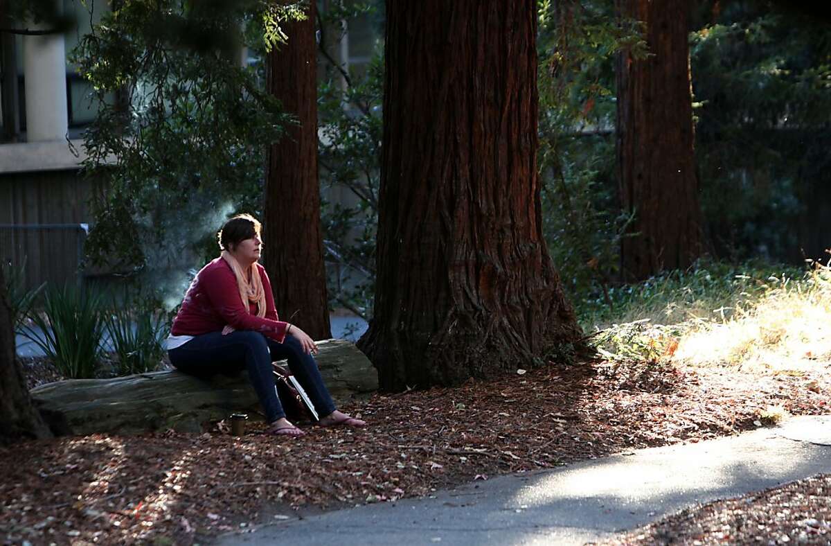 Kathleen Hall smokes at the creek next to Sathor Gate on the UC Berkeley campus in Berkeley, Calif., on Thursday, January 12, 2012. She said she used to go to Santa Rosa junior college where smoking was not allowed anywhere on campus. Starting in 2014 smoking will not be allowed anywhere on a UC campus.