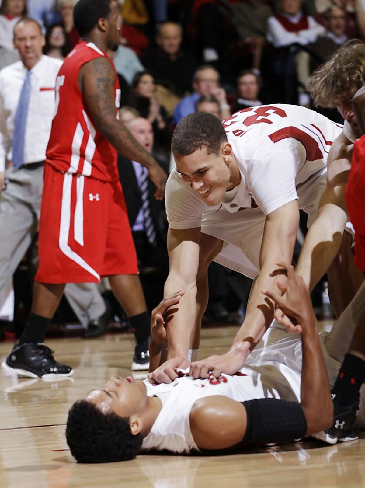 Stanford forward Josh Huestis is congratulated by forward Dwight Powell (33) after Huestis scored against Utah in the second half of an NCAA college basketball game in Stanford, Calif., Thursday, Jan. 12, 2012. Stanford defeated Utah 68-65. Huestis was Stanford's high scorer with 13 points. (AP Photo/Paul Sakuma)