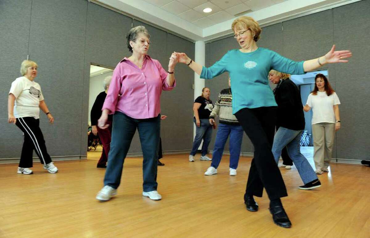 Flo LaRussell, 71, of Danbury, left, and Priscilla Brown, 72, of Bethel, who has bounce in her footsteps at a Thursday freestyle dance session at the senior center in Danbury.