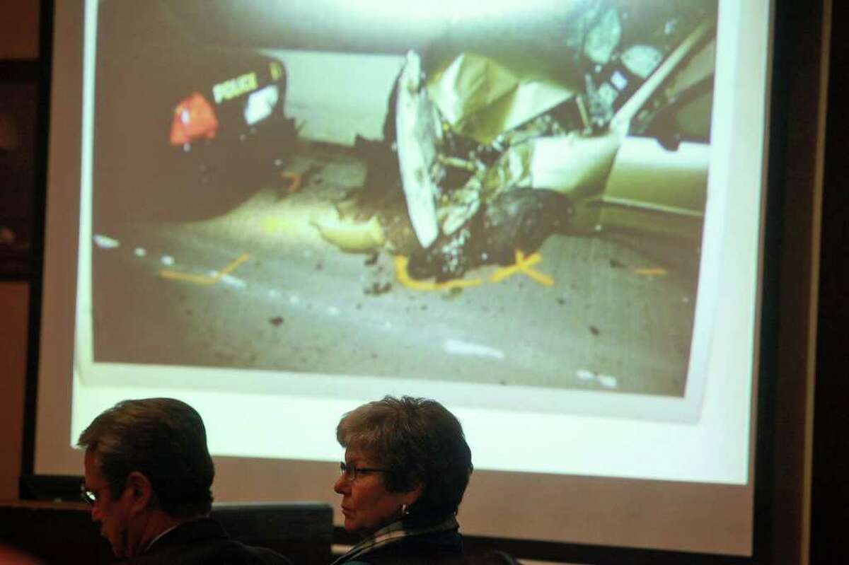 Sandra Briggs and her attorney, Edward Piker, watch as photographs are shown from the scene where SAPD Officer Sergio Antillon, 25, was hit by a car driven by Briggs.