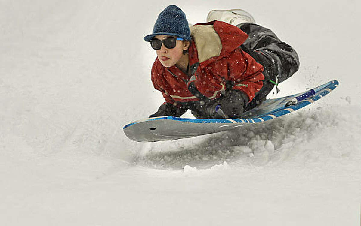 Thomas Sgarlato-Campi, 13, of Los Gatos speeds down a hill on his sled at Adventure Mountain Snow Park at Echo Summit. The California Department of Water Resources conducted their first snow survey of the winter season at nearby Phillips Station on Tuesday.