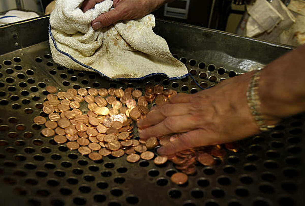 To rid the coins of the birdshot, Rob Holsen runs them over a large sifting device Monday December 20, 2010. Rob Holsen may be the only professional coin washer in the United States. He washes coins for the Westin St. Francis Hotel in Union Square, San Francisco, Calif., a tradition which began to keep ladies white gloves from getting tarnished back in the 1930s.