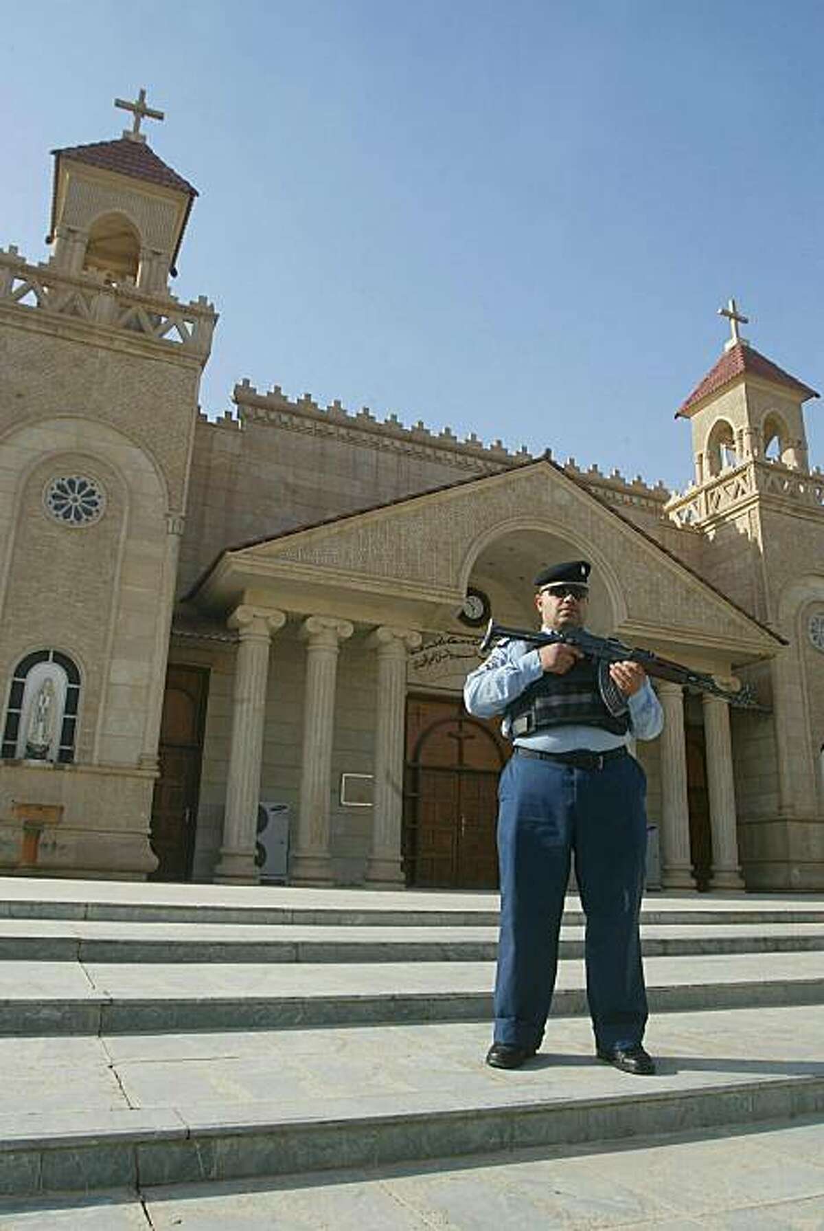 An Iraqi policeman stands guard outside a church in the ethnically mixed northern Iraqi city of Kirkuk on December 21, 2010 as part of security measures to protect Christians, after 44 worshippers were killed in a late October attack on a Baghdad church.