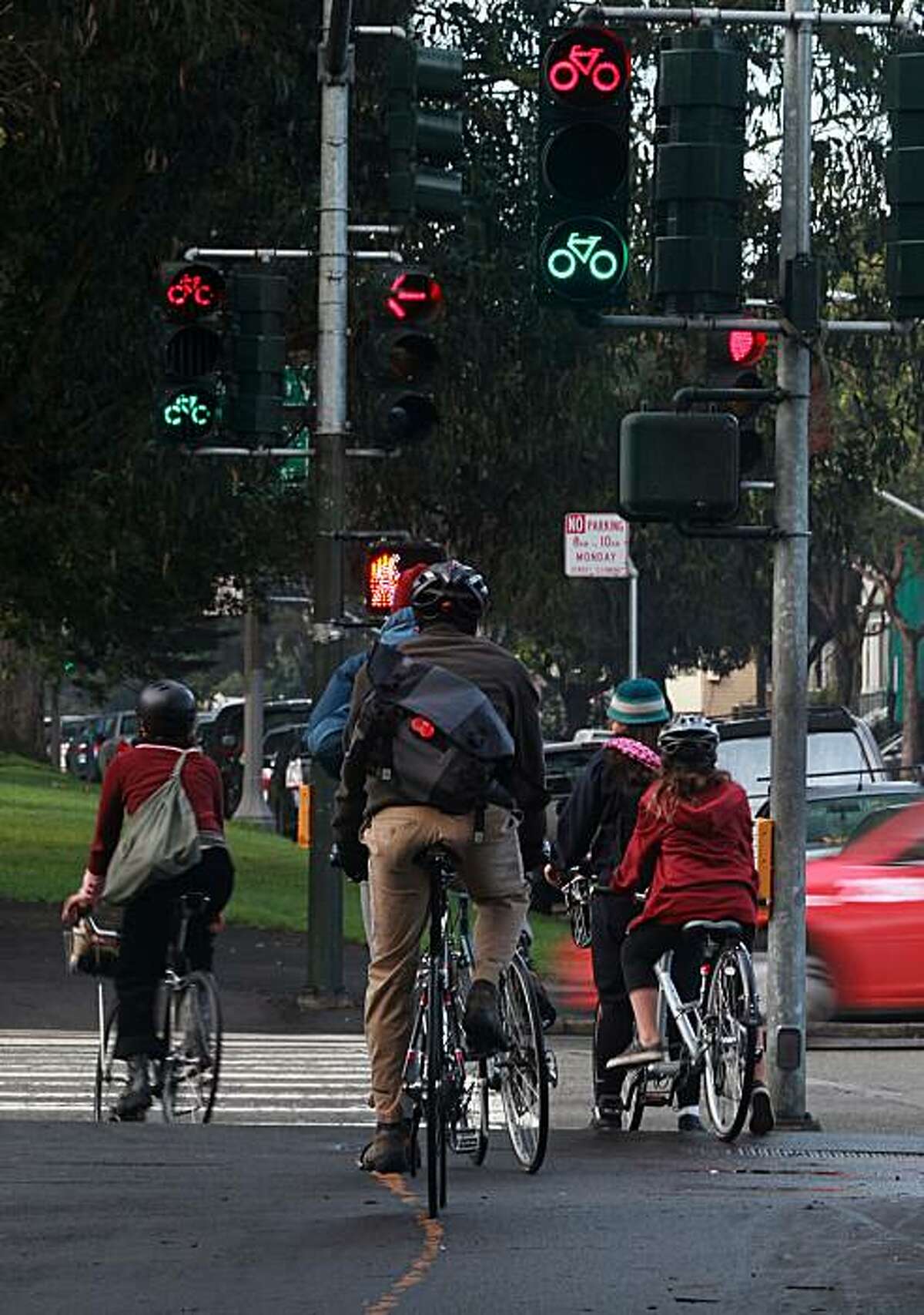 Cyclists wait for the traffic light between signals on Fell at Masonic streets in San Francisco, Calif., on Wednesday, December 15, 2010.
