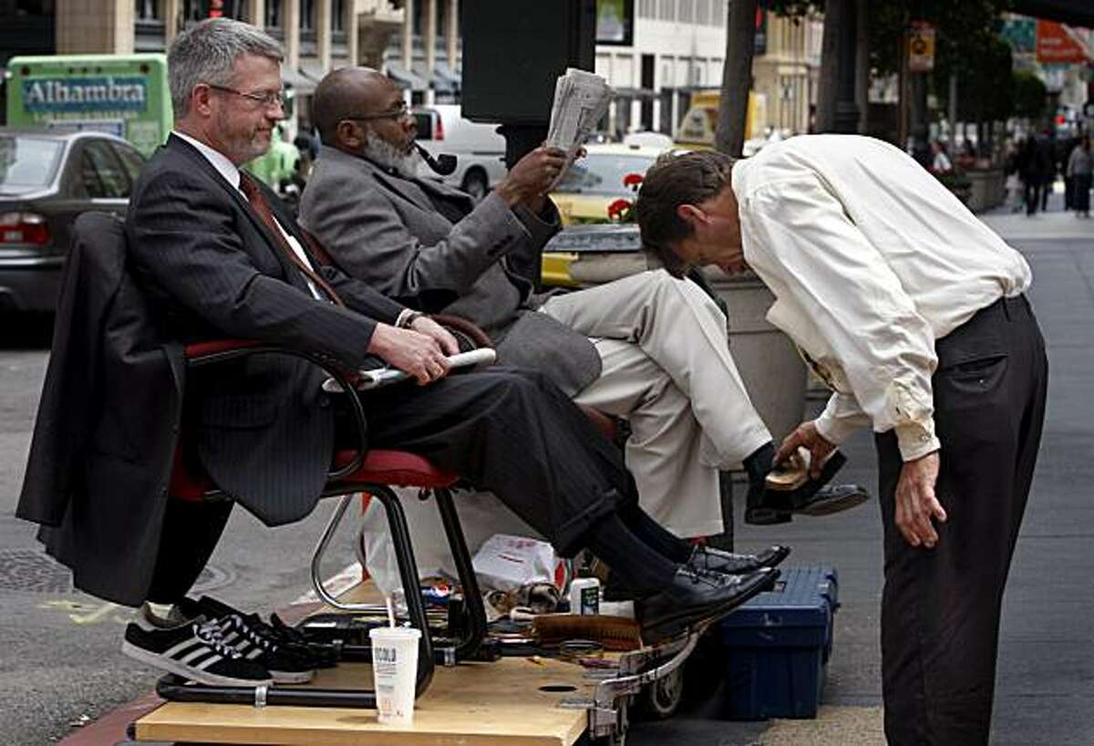 Bruce McCoy (left) has his shoes shined by Larry Moore while another customer Anthony Garner (center) waits his turn at Market and New Montgomery streets in San Francisco, Calif., on Thursday, June 4, 2009.