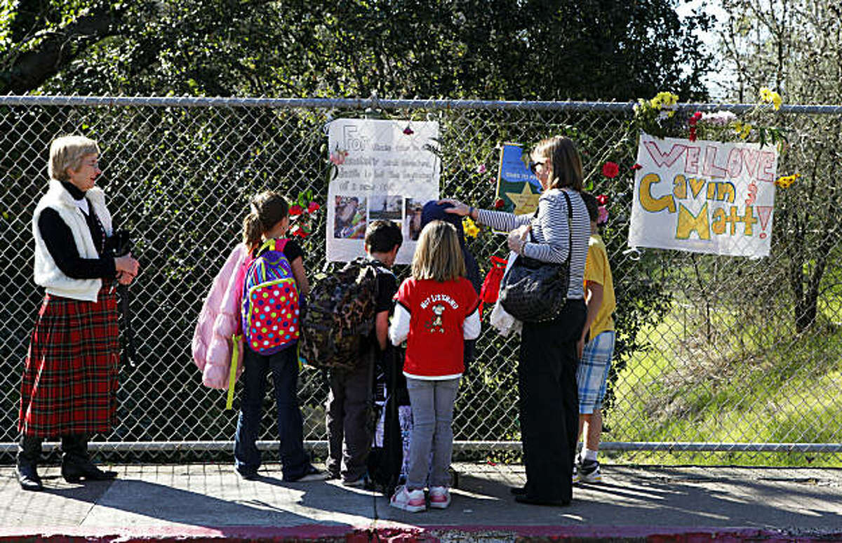 School children from Murwood Elementary school in Walnut Creek stop to read signs at a makeshift memorial for Matthew Miller and Gavin Powell Tuesday Feb 22, 2011. The two Las Lomas high school students drowned while trying to navigate the rain-swollen creek in a two-person inflatable raft this past weekend.