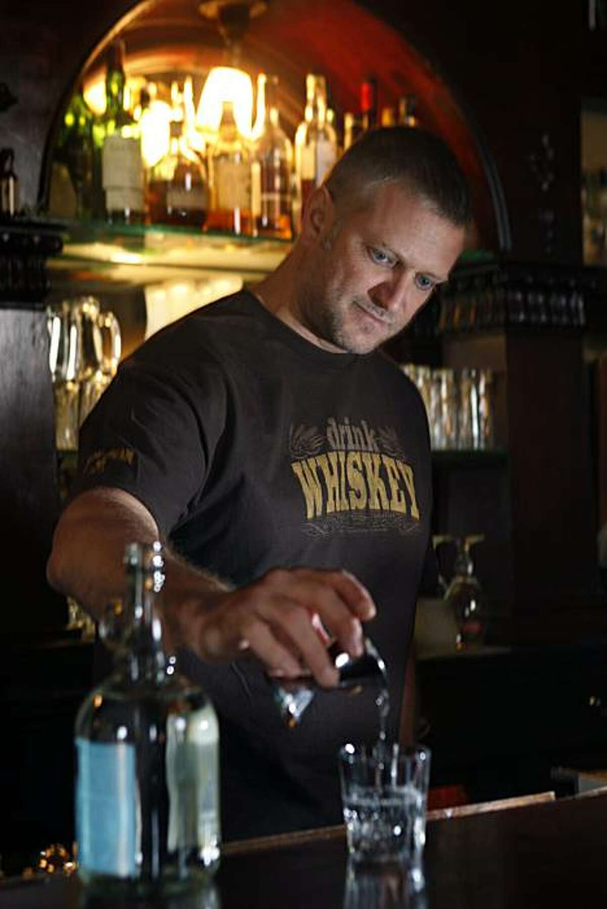 Elixir offers several moonshine including Marco K. Spirits' Doubled & Twisted IPA Whiskey Light which bar owner H. Joseph Ehrmann is pouring on Wednesday, February 10, 2010, in San Francisco, Ca.
