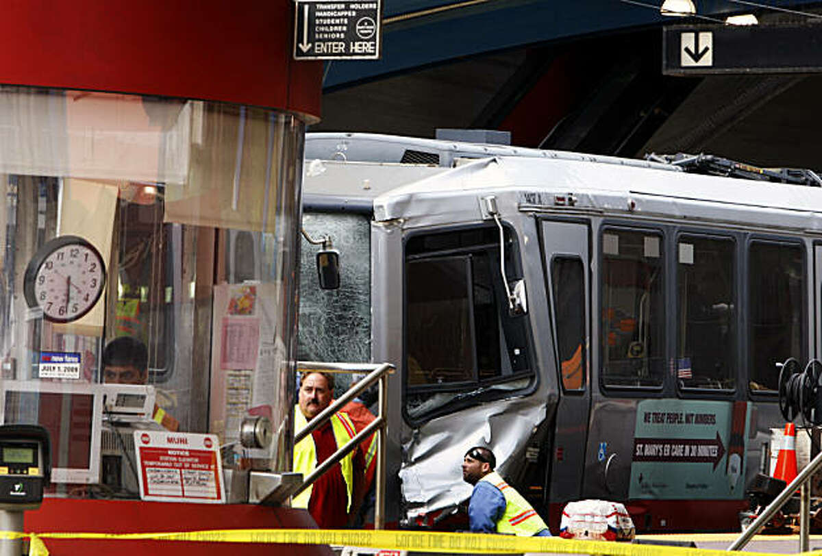 Muni personal look over the two trains involved in an afternoon collision at the West Portal Station July 18, 2009. Nine of the injured with critical injuries were transported to San Francisco General Hospital Saturday; other local hospital treated over thirty other victims.