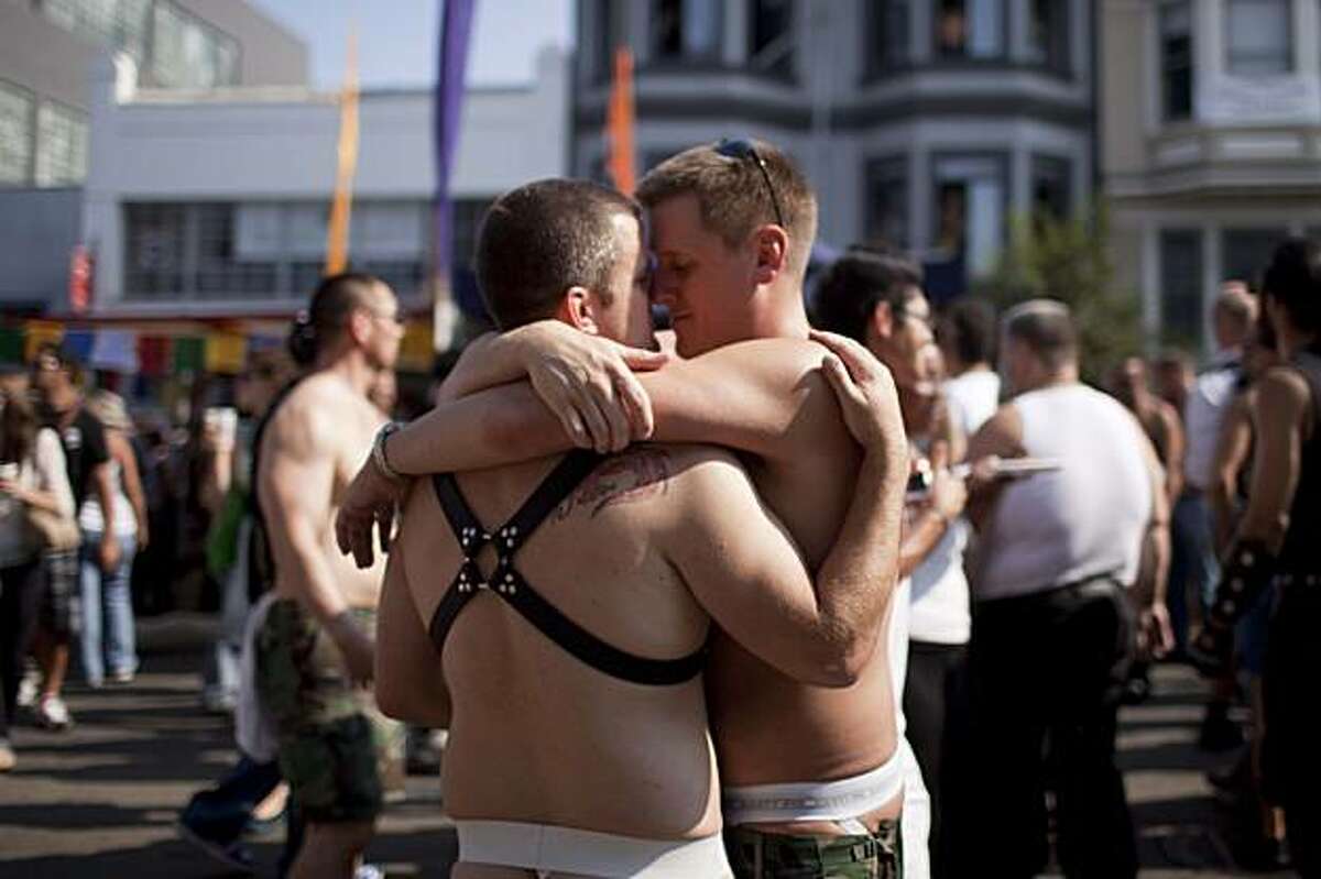 Stephen Yardbrough (right) of San Francisco embraces a friend at the annual Folsom Street Fair in San Francisco on Sunday.