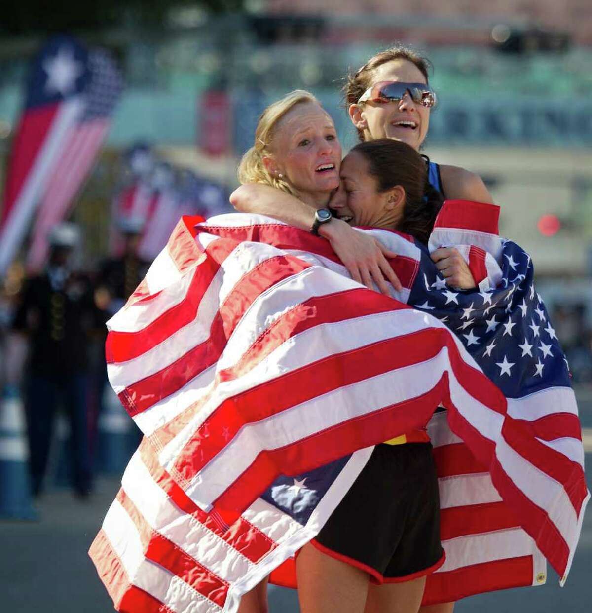 The top three finishers, from left, Shalane Flanagan, Desiree Davila and Kara Goucher celebrate after securing their spots on the team for the 2012 Olympics at the women's U.S. Olympic Trials Marathon. A Trials record five women finished under 2:30 in the race.