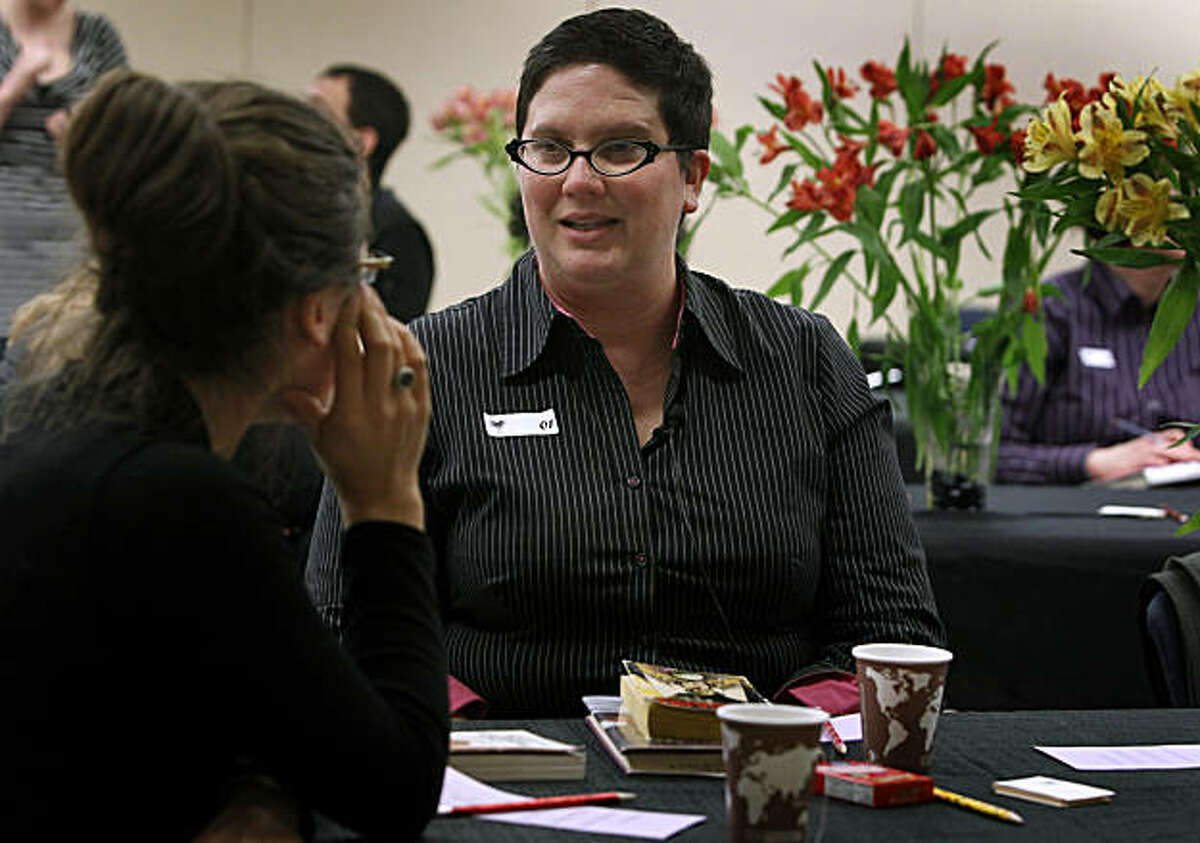 Iris Tashjian (center) and another participant talk about their favorite books while getting to know each other at a speed dating event for the LGBT community at the Main Library in San Francisco, Calif., on Wednesday, Feb. 2, 2011. Participants were encouraged to bring their favorite book as a conversation starter.
