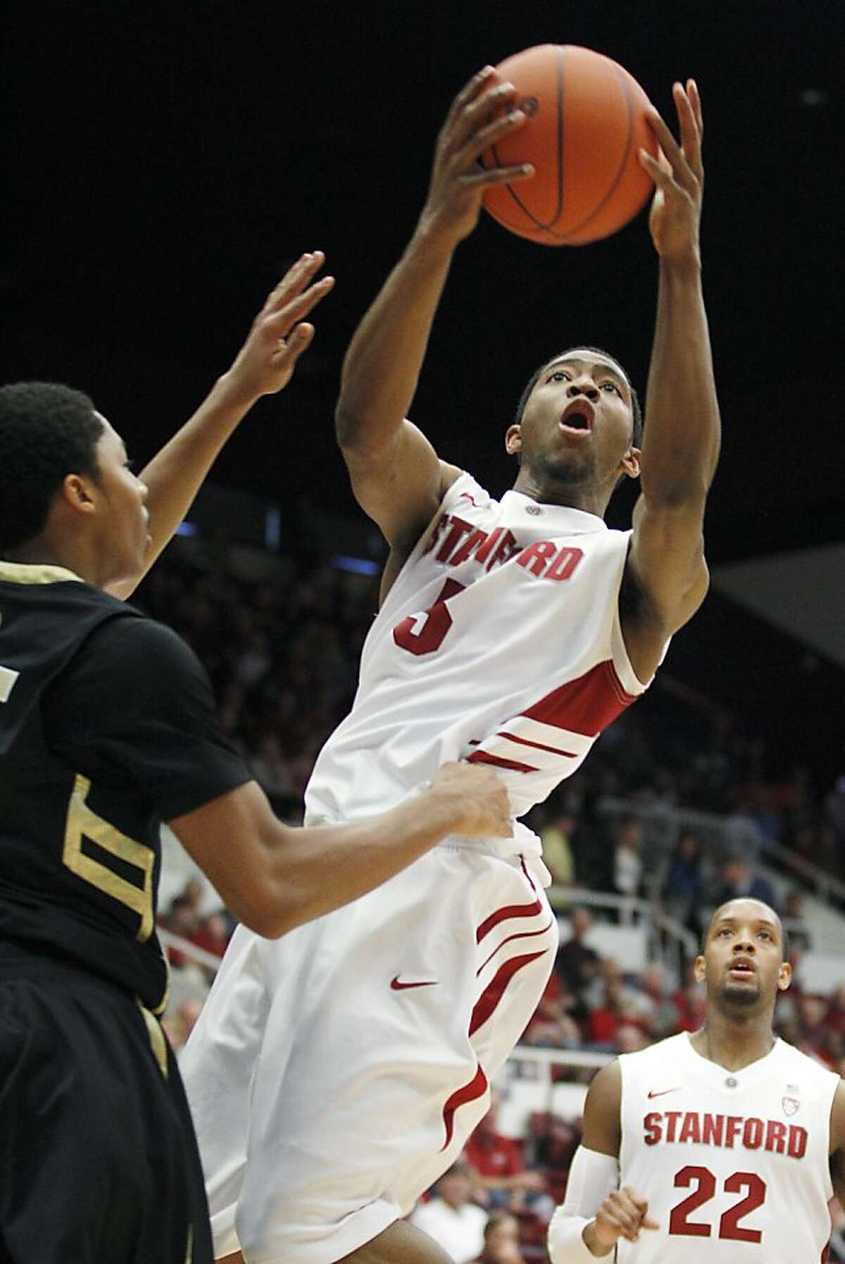 CORRECTS STANFORD PLAYER NAME TO CHASSON RANDLE (5), NOT ANTHONY BROWN (3) - Stanford's Chasson Randle (5) drives to the basket against Colorado's Spencer Dinwiddie, left, in the first half of an NCAA college basketball game on Saturday, Jan. 14, 2012, in Stanford, Calif. (AP Photo/Tony Avelar)