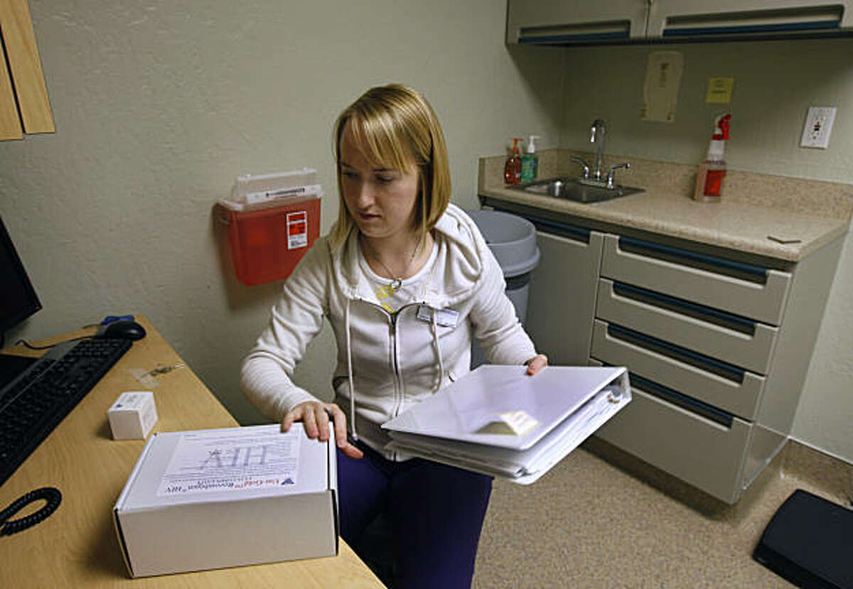 Reproductive health specialist Julie Frazier organizes one of the six exams rooms to prepare for the opening of the new Planned Parenthood health clinic in San Francisco, Calif., on Tuesday, Jan. 18, 2011.