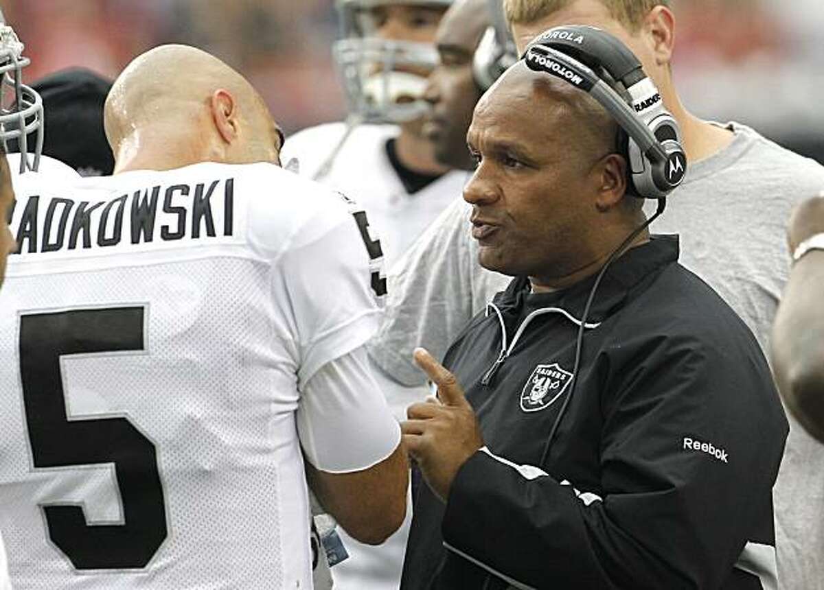 Oakland Raiders offensive coordinator Hue Jackson, right, talks with Raiders quarterback Bruce Gradkowski (5) during a timeout during an NFL football game against the Arizona Cardinals Sunday, Sept. 26, 2010, in Glendale, Ariz. The Cardinals defeated the Raiders 24-23. (AP Photo/Ross D. Franklin)