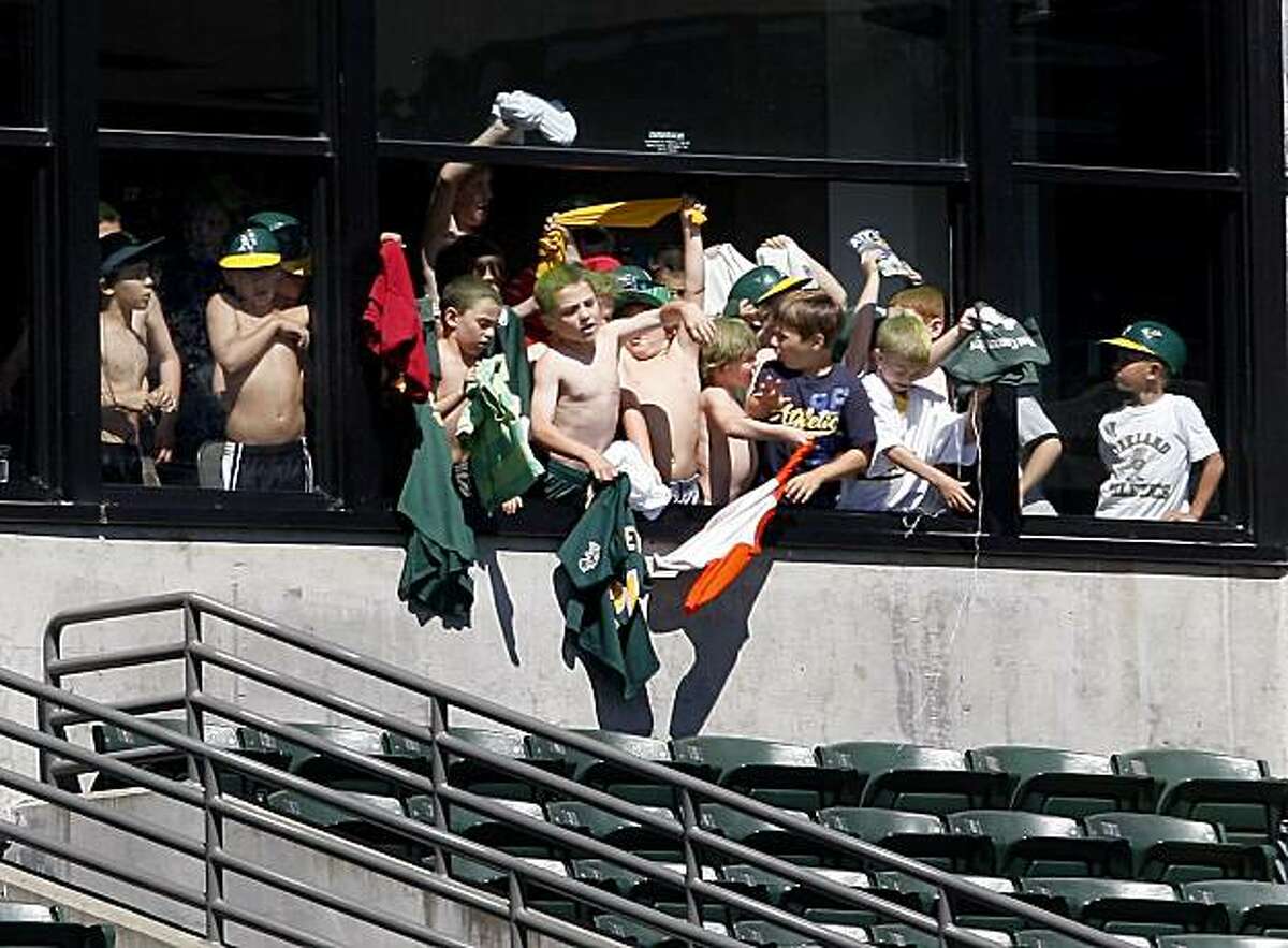 Real Fans - 4 p.m. - Oakland. Just as things looked desperate for the Oakland A's as they played the Minnesota Twins recently, a group of kids in the luxury boxes flung off their shirts and rallied the home team. Whew. Camera settings: Canon 5D MkII, ISO 250, 1/500, f4.5, 400mm.