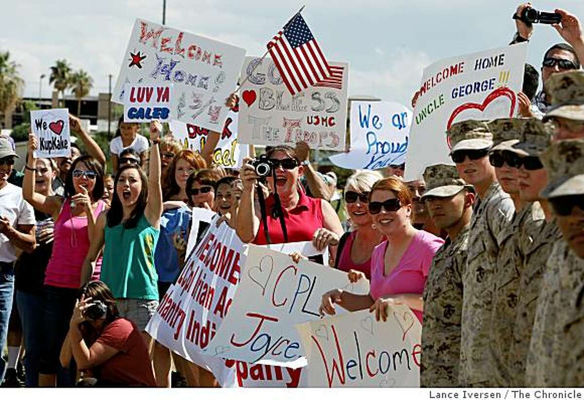 Family and friends cry out to their loved ones as the first Marine battalion to be sent to Iraq for a fifth tour returned to their home base in Twenty Nine Palms, Calif., on Thursday Sept 18, 2008.